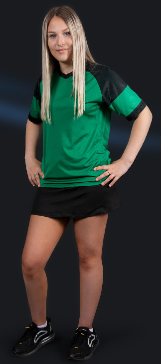 Young woman in sports jersey and shorts posing with hands on hips