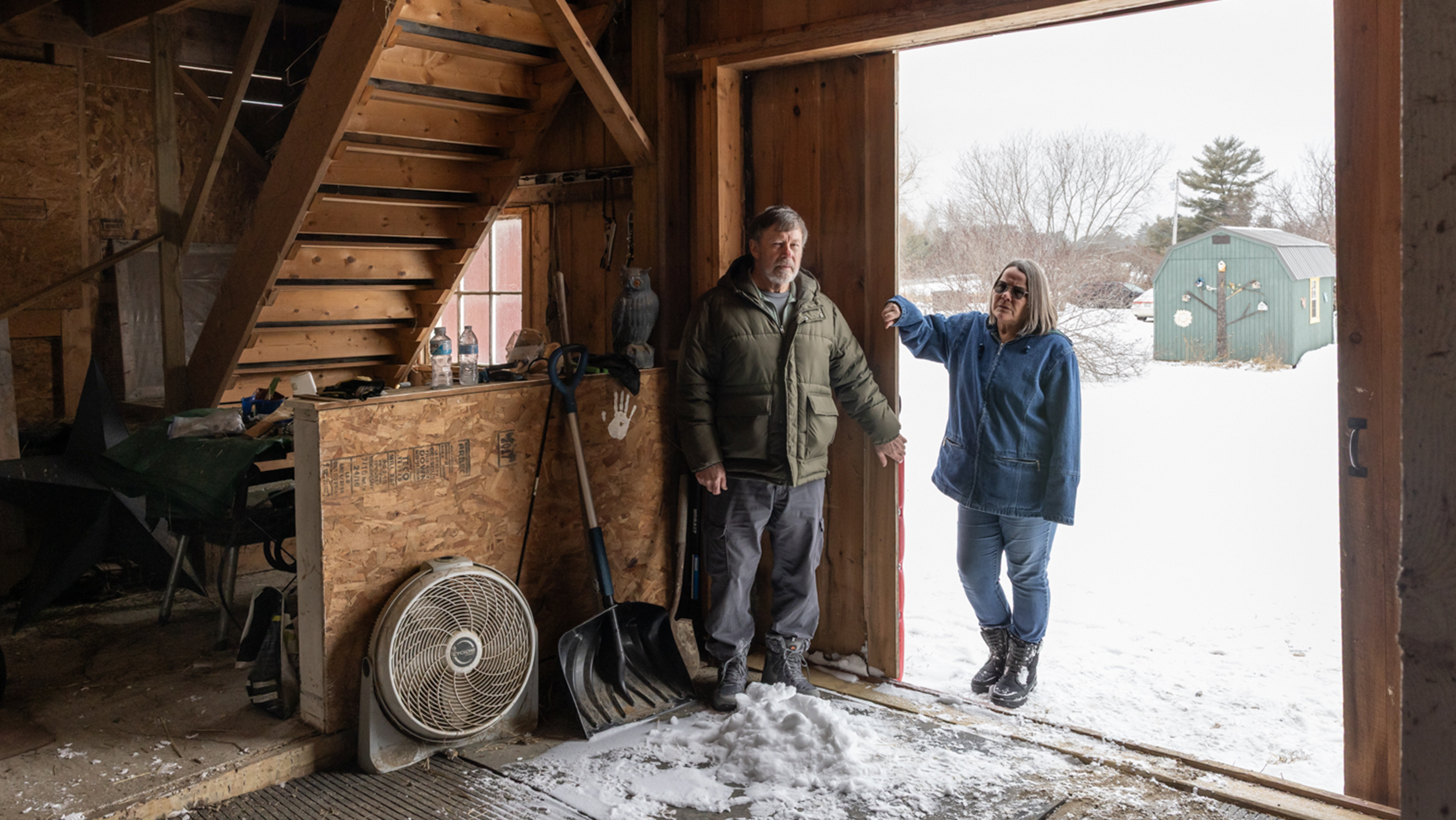 The farming couple in their barn doorway