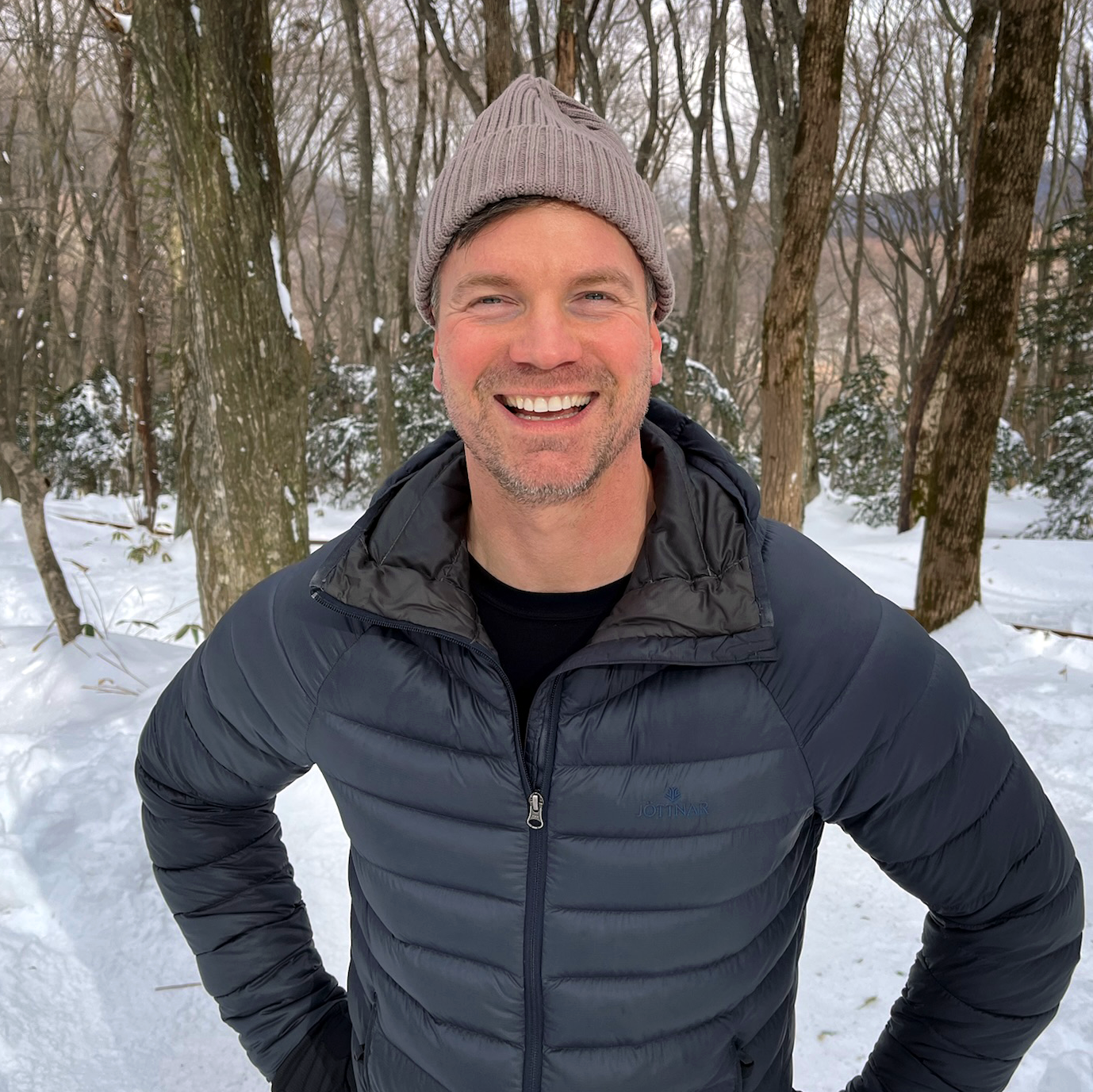 Martin Soendergaard smiling in a snowy forest