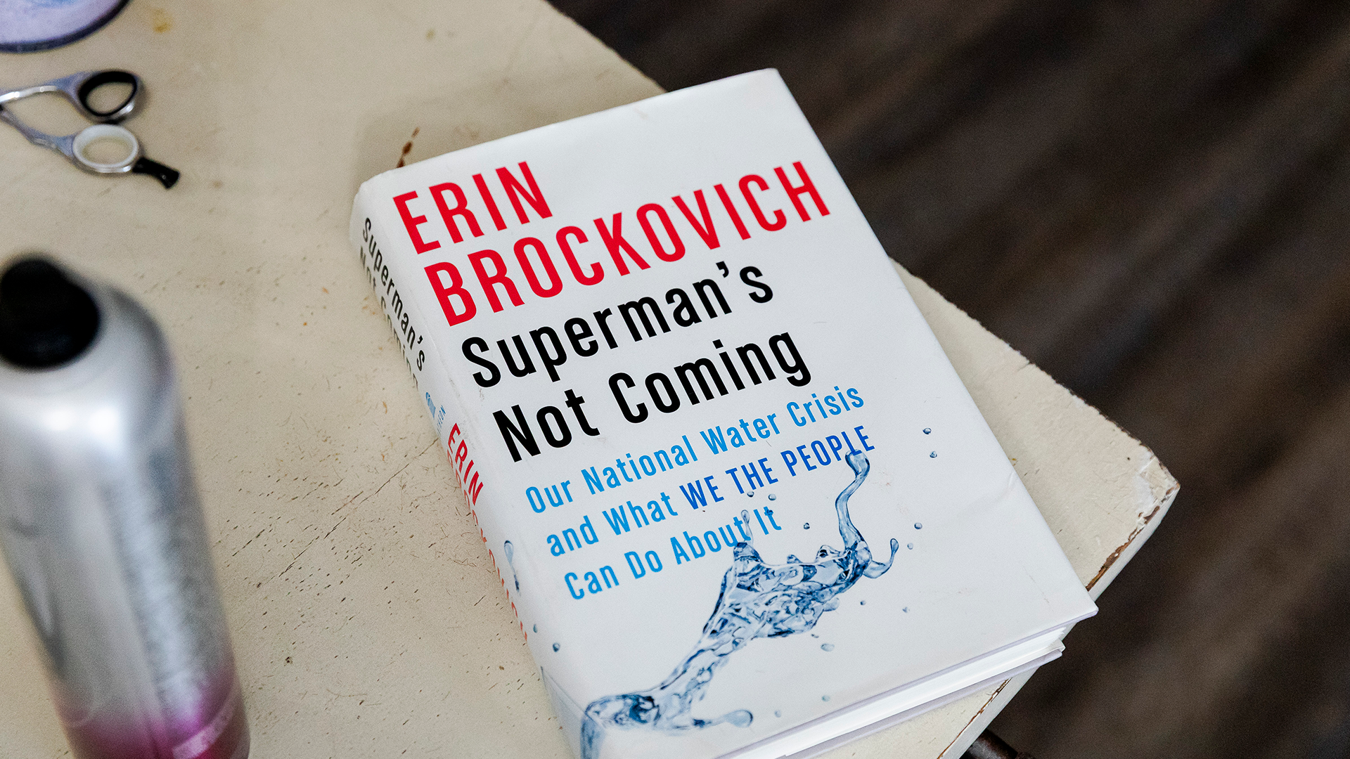 Erin Brockovich's book Superman's Not Coming on a table