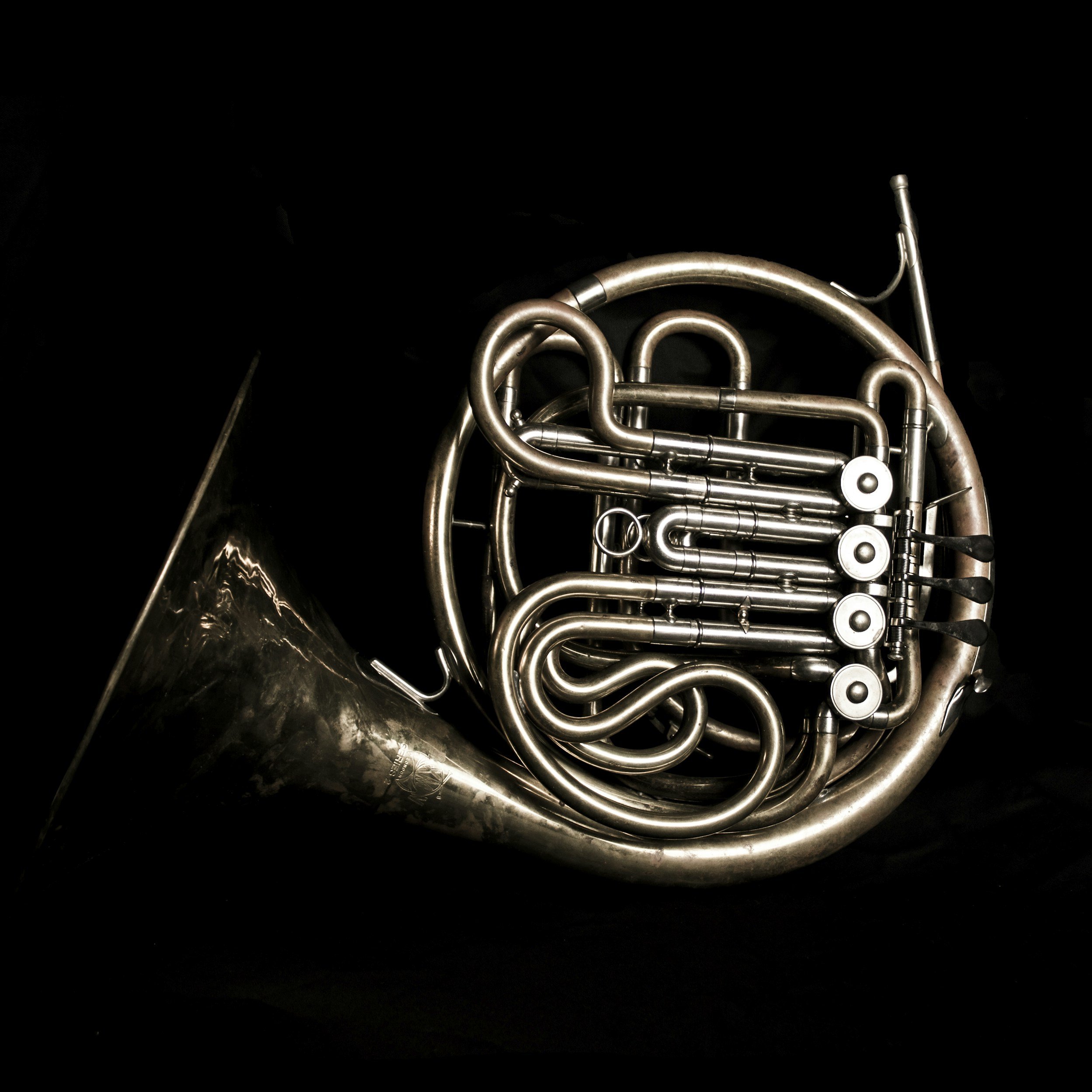 Close-up of a brass instrument showing surface tarnish and metal finish.