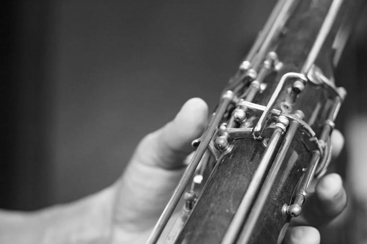 Hand holding a bassoon showing keywork and fingering system