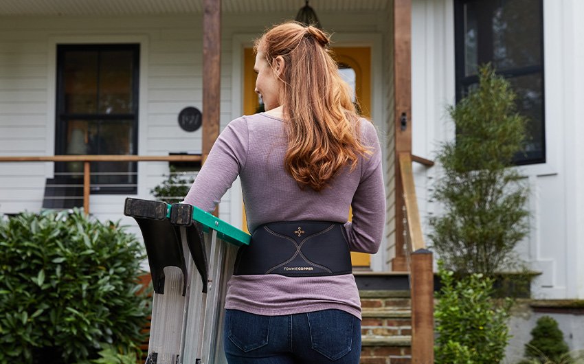 callout-ComfortBackBrace_woman-with-ladder.jpg