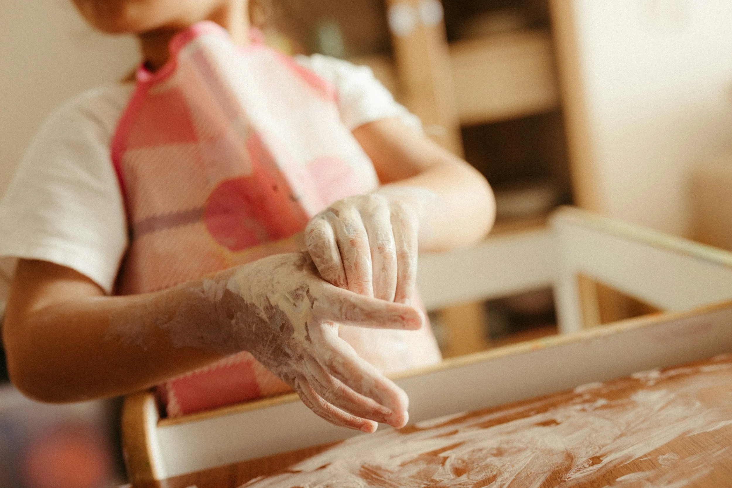 One child baking with flour on his hands