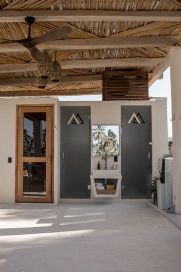 The serene sauna entrance at Alchemize House Sayulita, showcasing natural aesthetics and wellness-focused design.