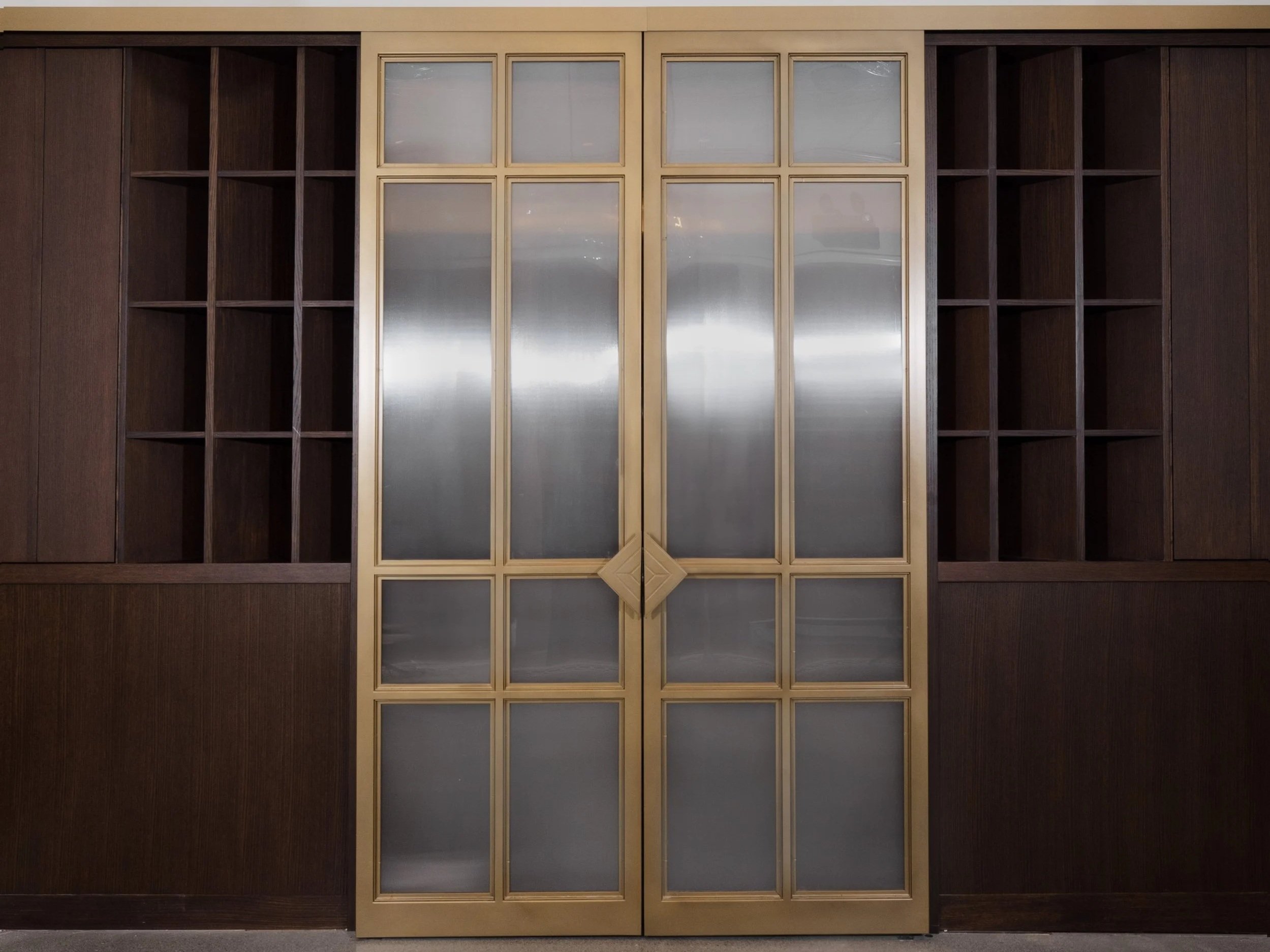 The brass-framed glass doors of the Welcome Foyer at Class Act Chicago.