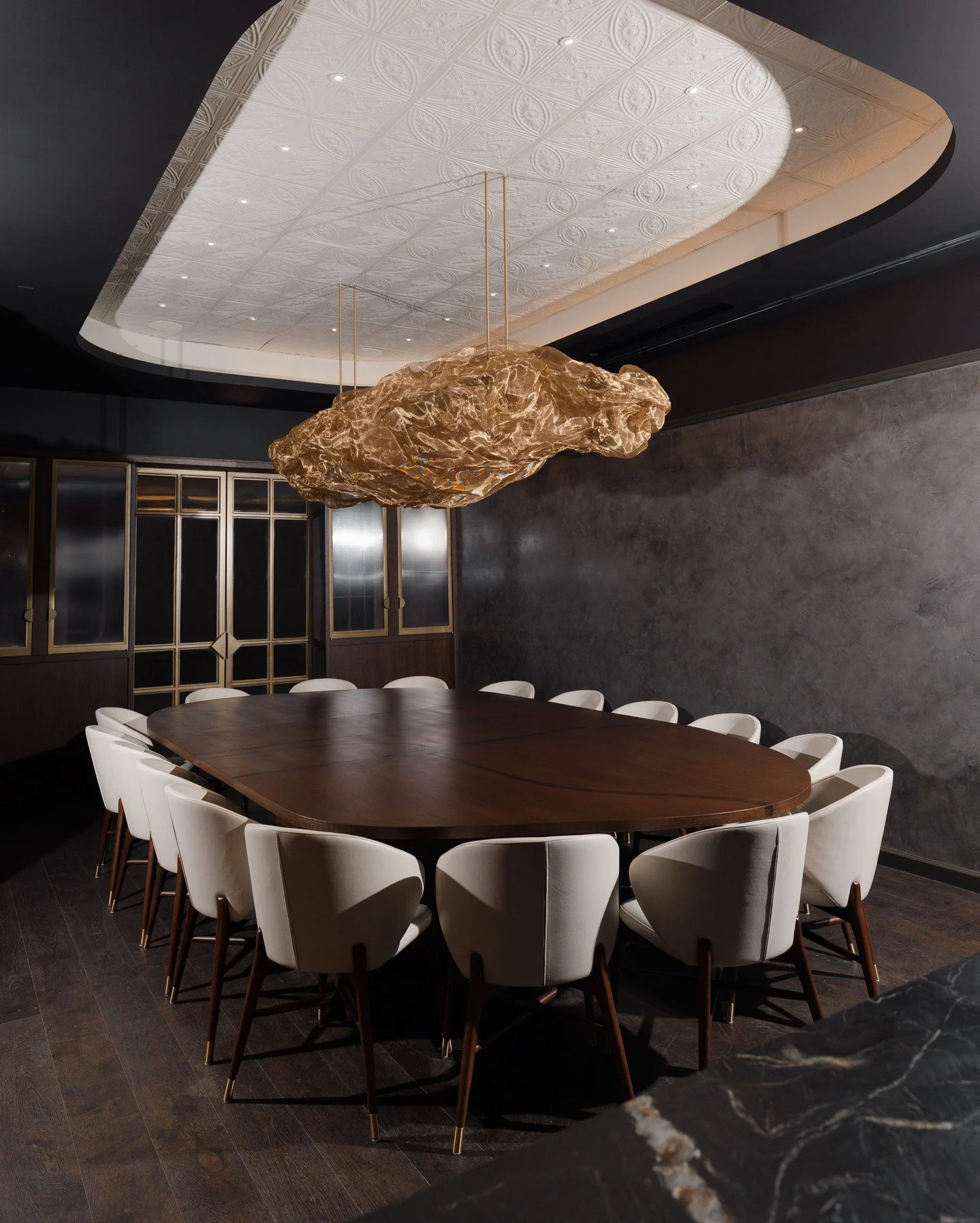 One table. Sixteen strangers.

By the end of the night, something shifts. 

There's something about being seated together &mdash; not across from a date or beside a colleague, but shoulder to shoulder with people you've never met &mdash; that opens s