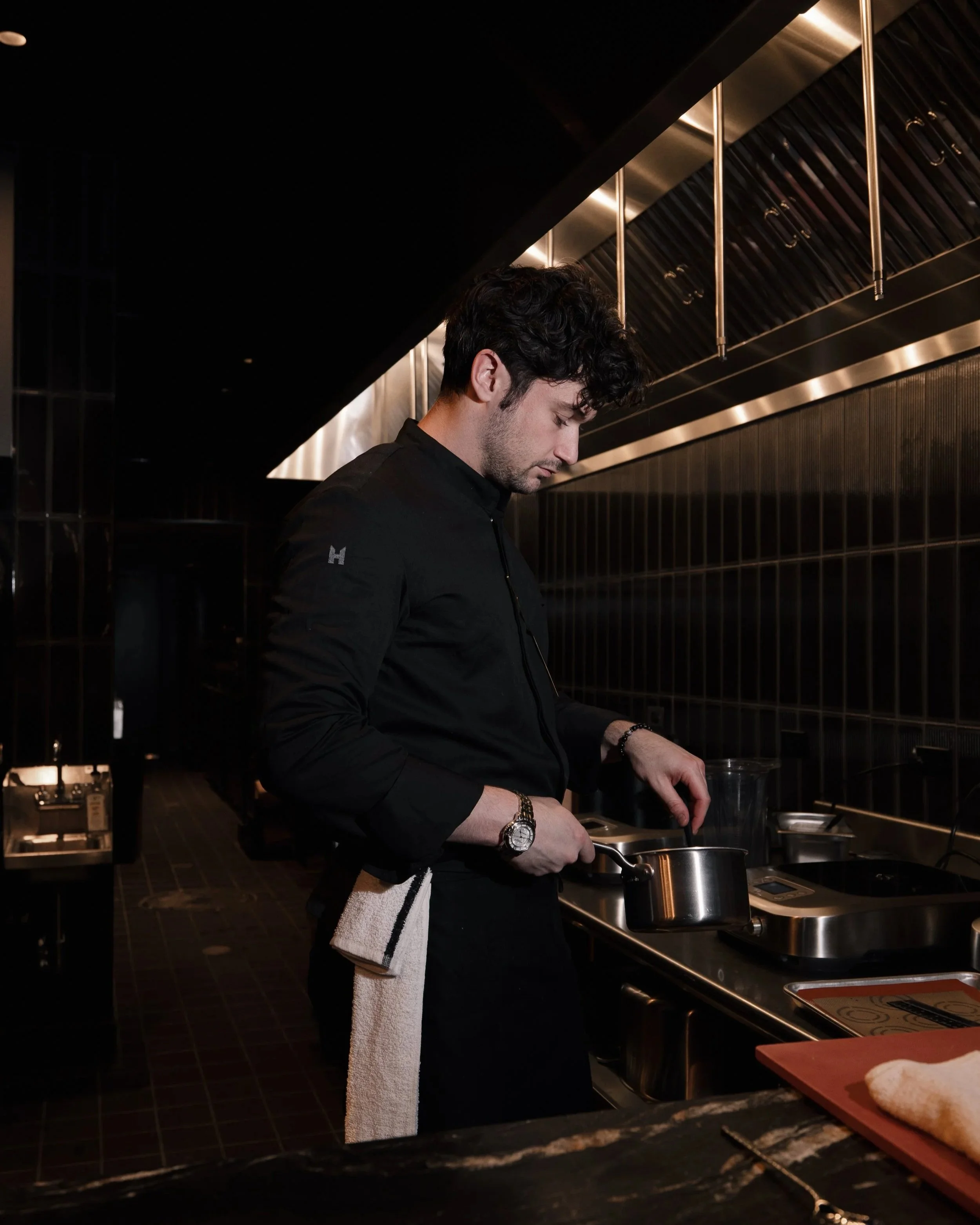 Chef Nicolai Mlodinow cooking at the open kitchen at Class Act Chicago.