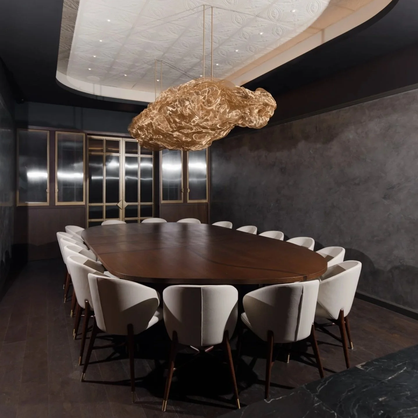 The private dining room at Class Act Chicago set for sixteen beneath the gold sculptural light.