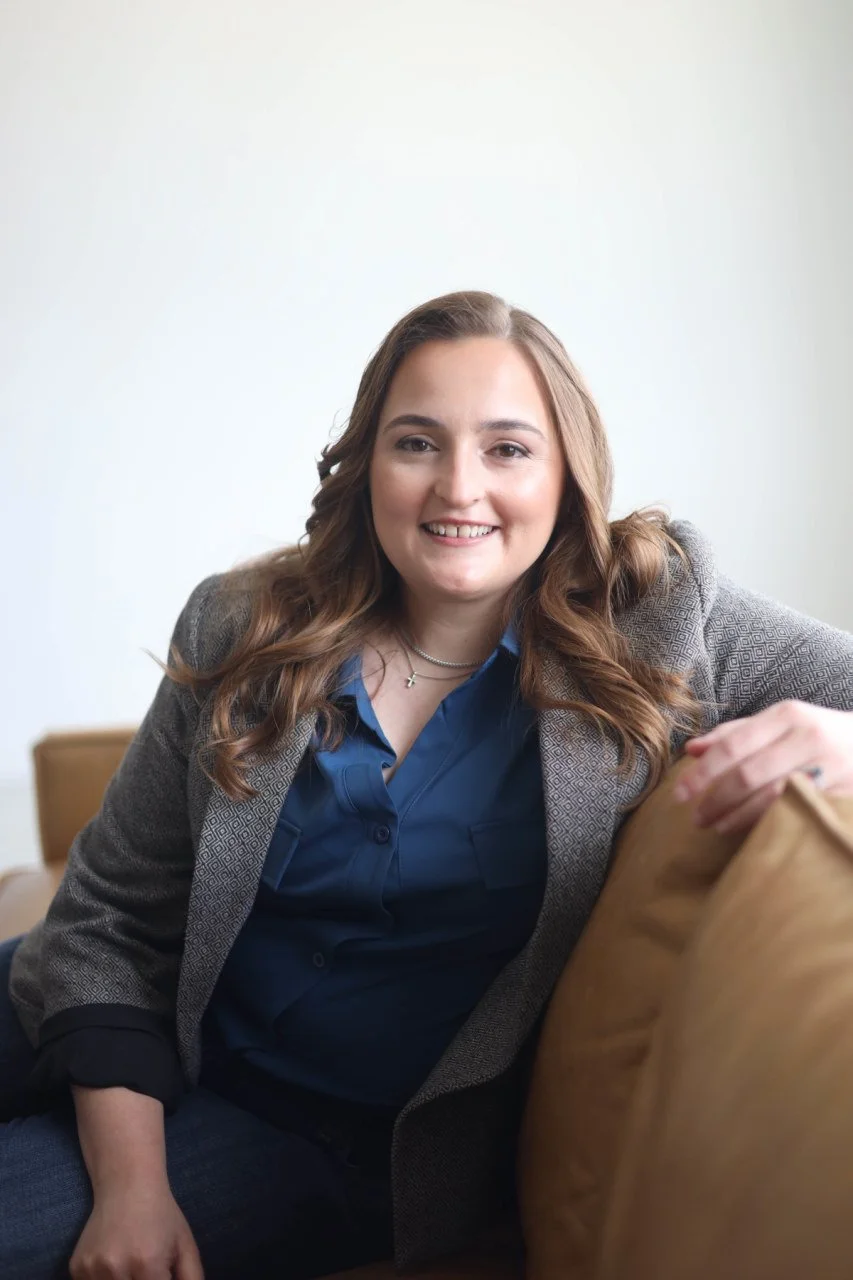 Dallas, Texas trauma therapist and counselor Kayla Bryant sitting in a chair looking at the camera. Learn more about EMDR therapists in Dallas, TX here.