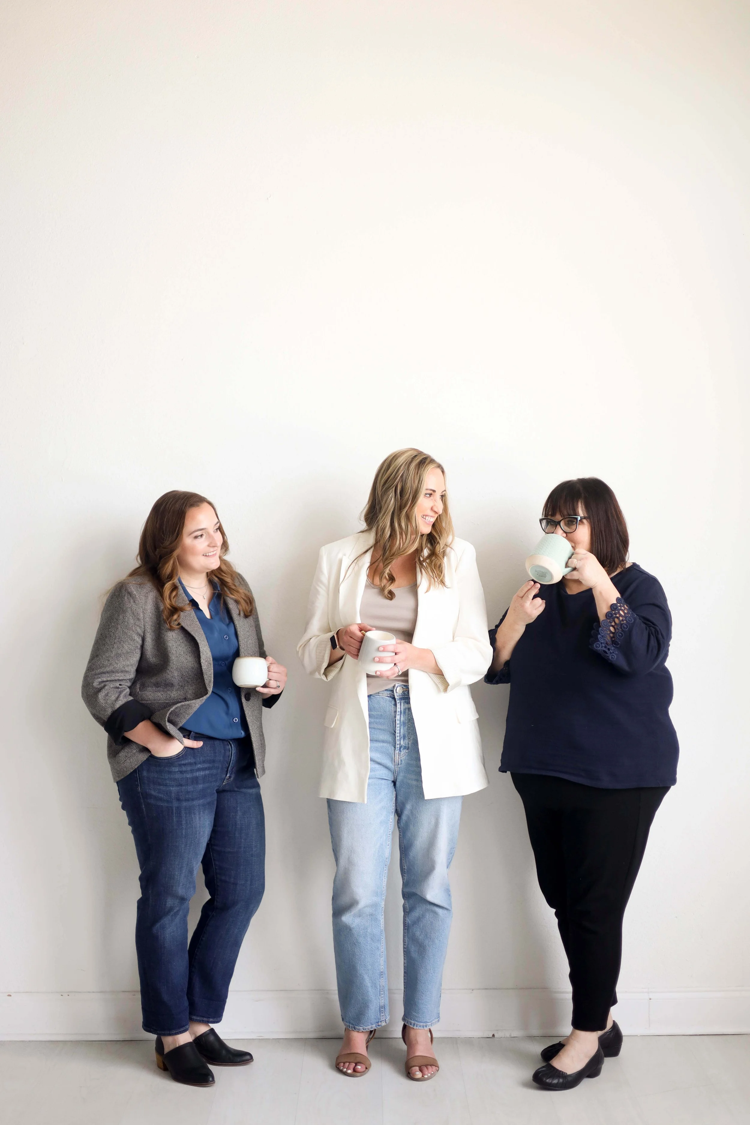 Expert trauma therapists in Dallas, TX standing and looking comfortable between counseling sessions in-person at Dallas Counseling Center.