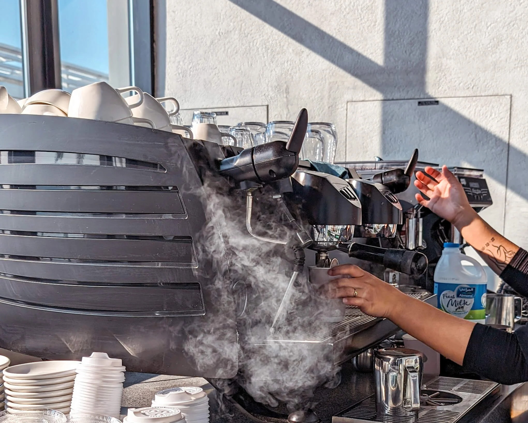 Image shows steam coming from a coffee machine
