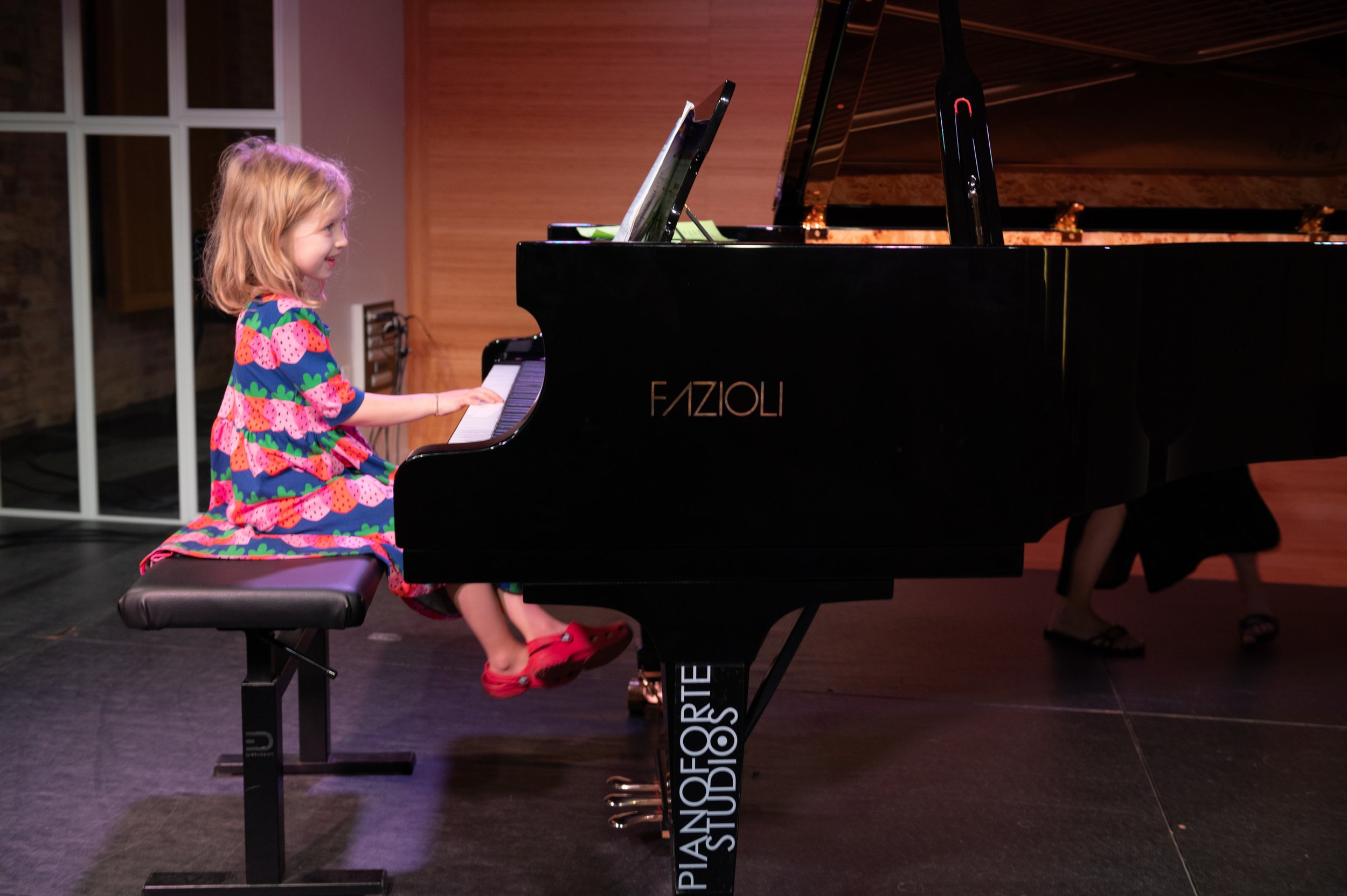 A budding young pianist rocking the stage at the Summer Recital