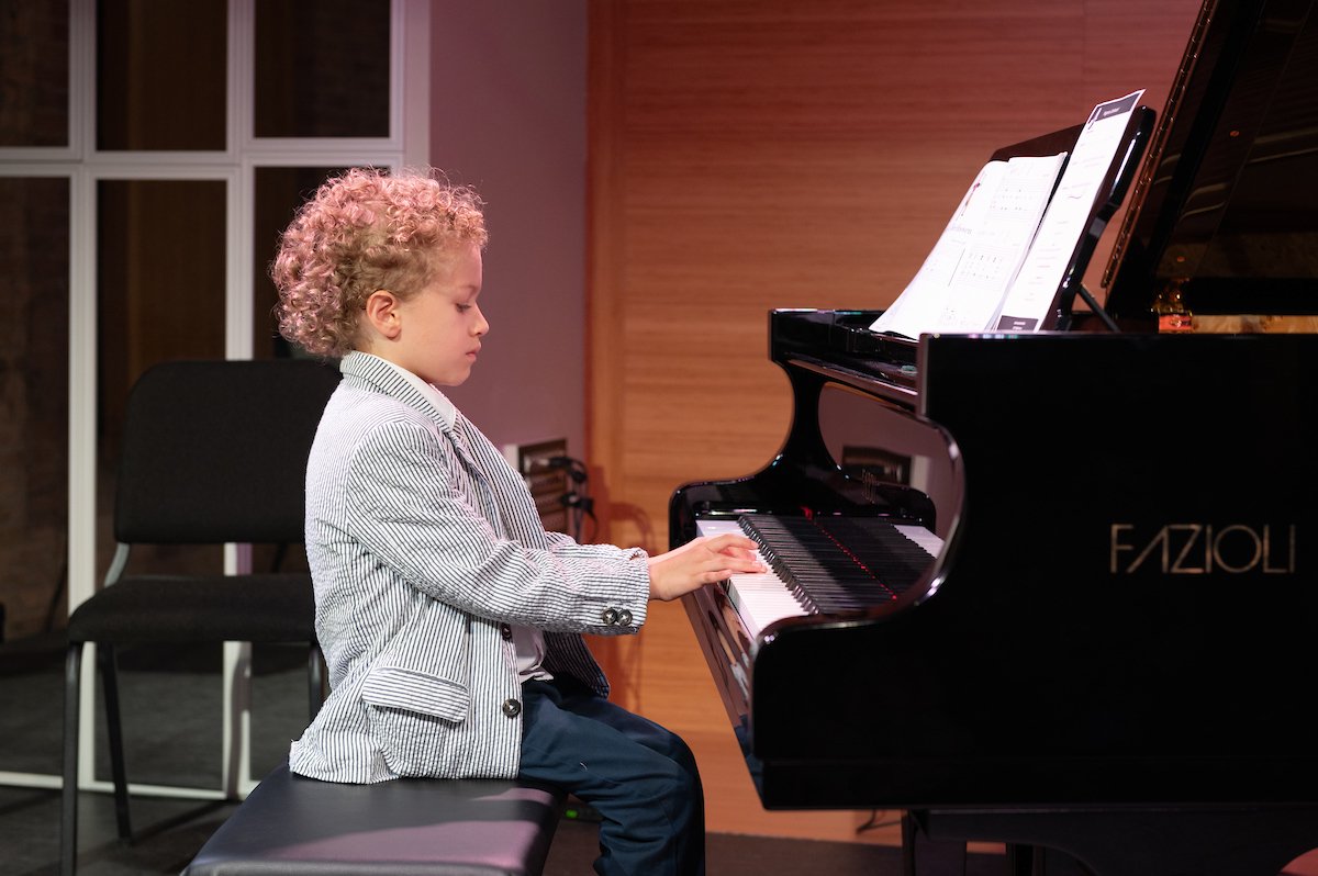 playing piano at South Loop School of Music's summer 2023 recital