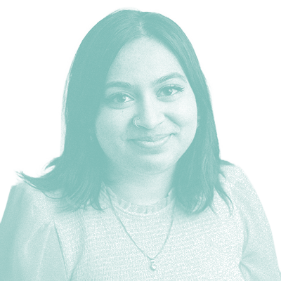 grainy teal monochrome photo of Simran Chahal. She has shoulder-length dark hair and is smiling