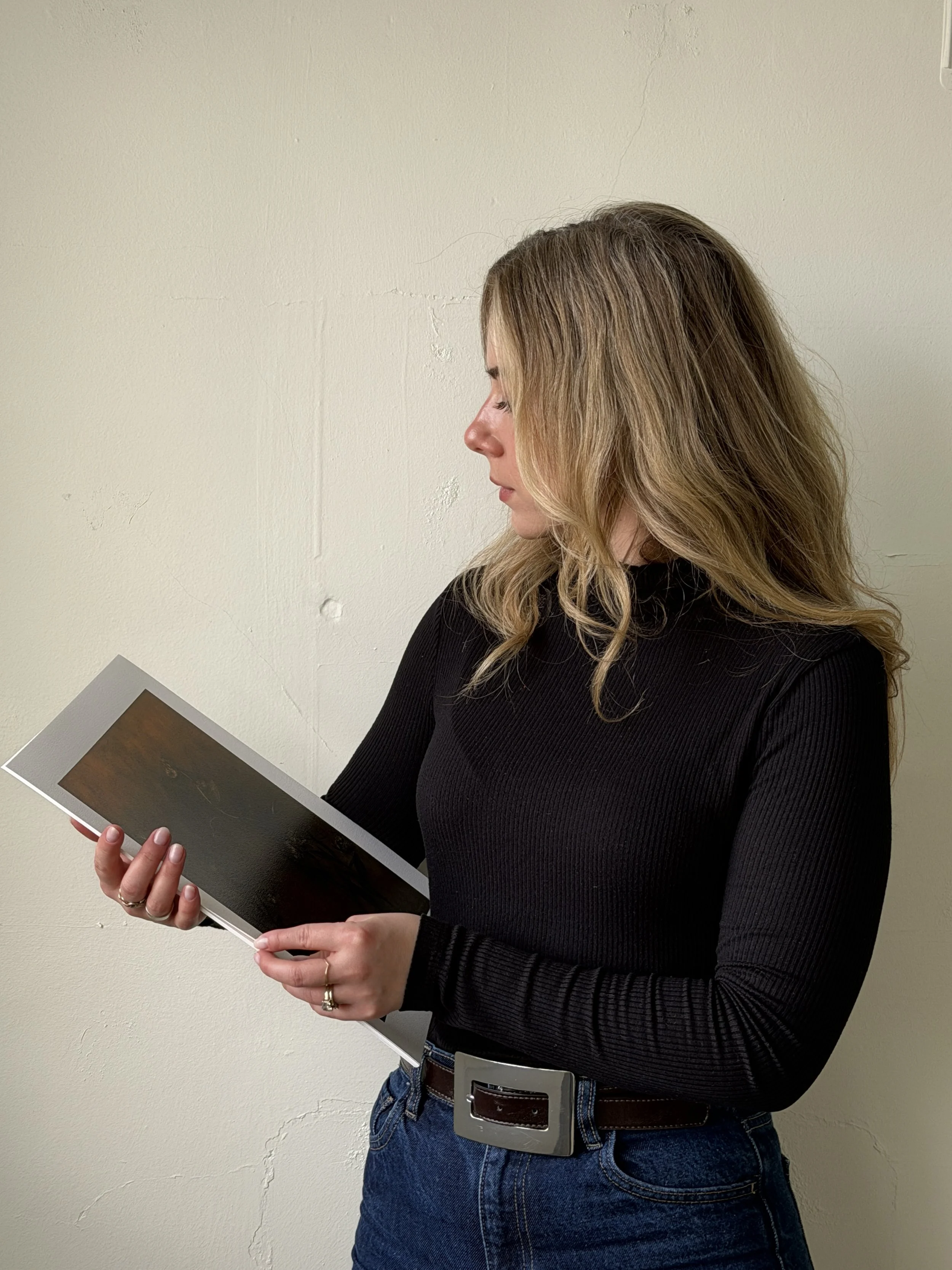 Artist holding art prints