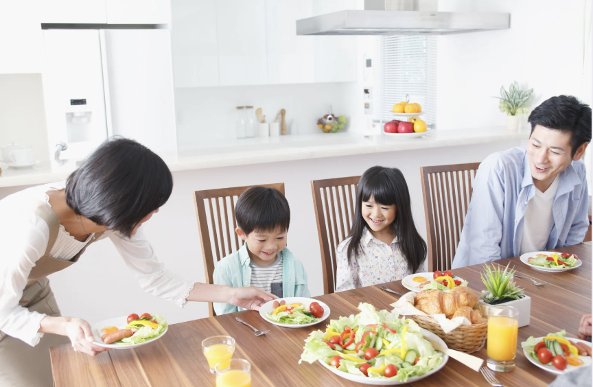 image of an Asian family eating salad together.
