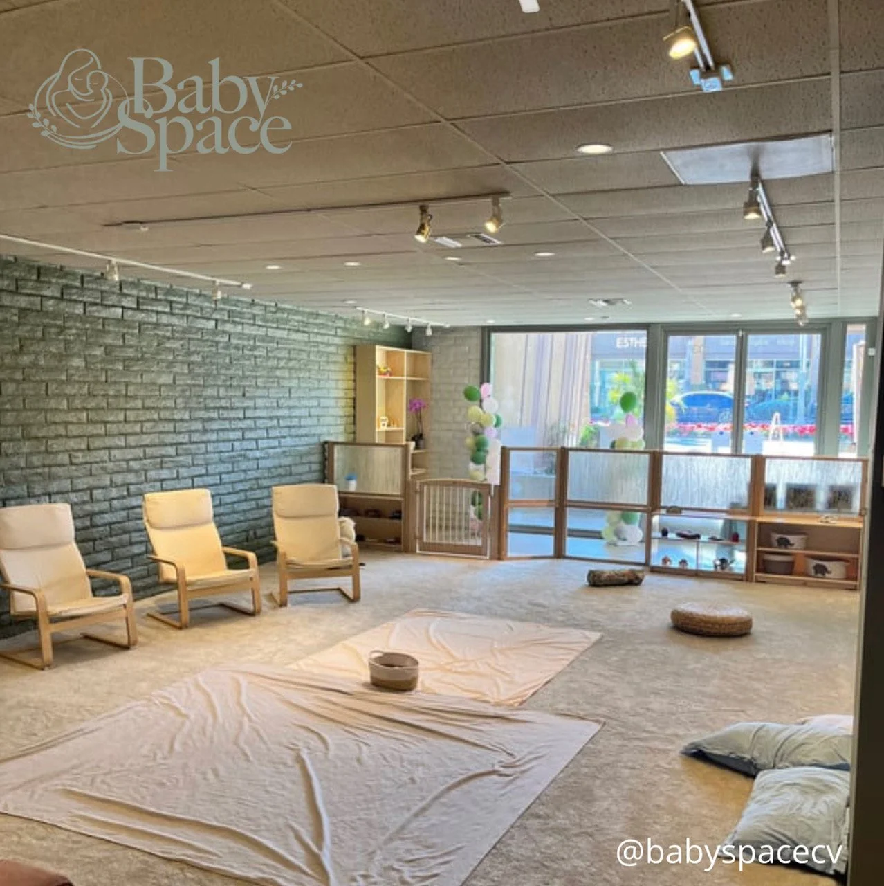 image of playroom at babyspace coachella valley with sheets covering the carpet for infants to explore