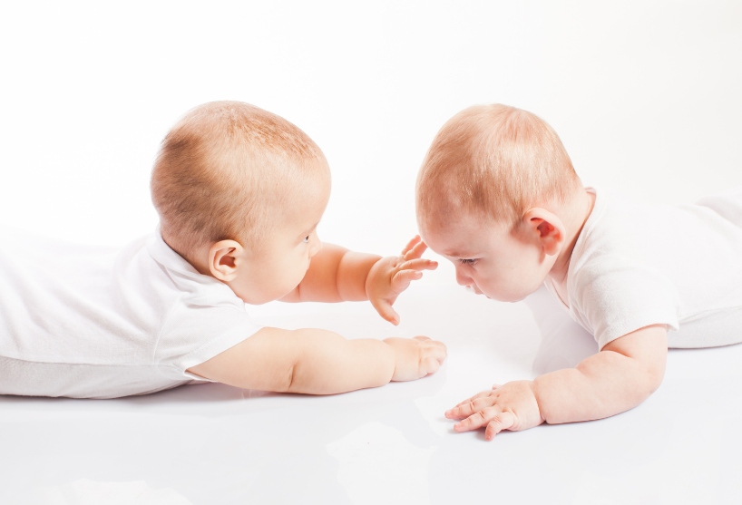 image of two young infants lying on their stomachs at BabySpace Coachella Valley