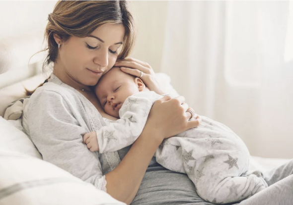 new mother holding newborn baby postpartum support palm desert