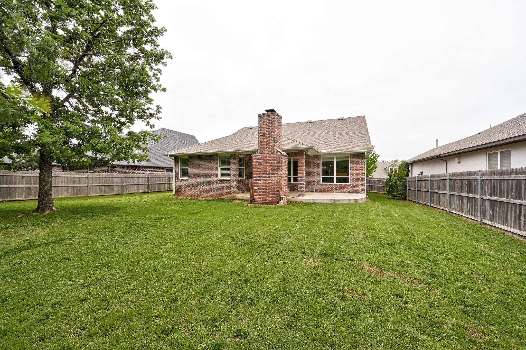 34-backyard-rear-exterior-brick-home-fenced-yard.jpg