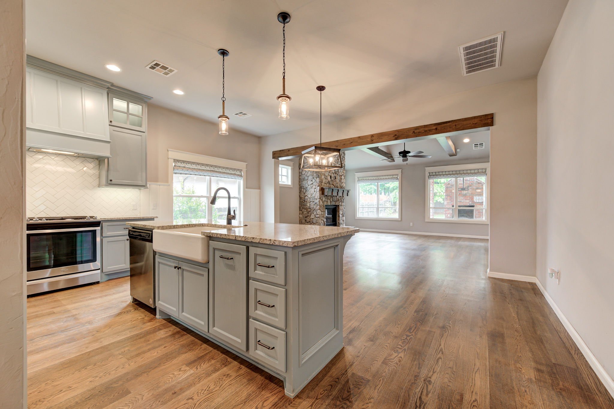 05-open-concept-kitchen-living-room-stone-fireplace.jpg