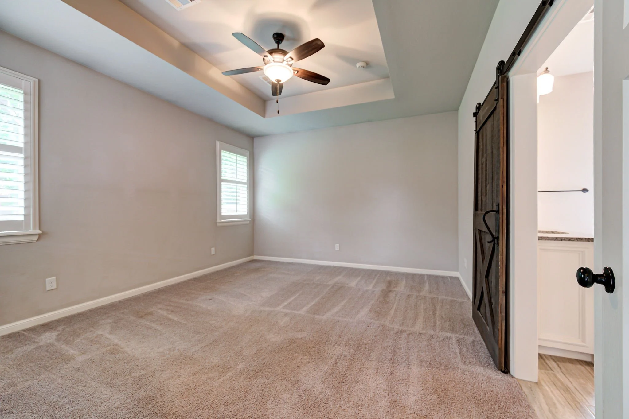17-master-bedroom-tray-ceiling-barn-door.jpg