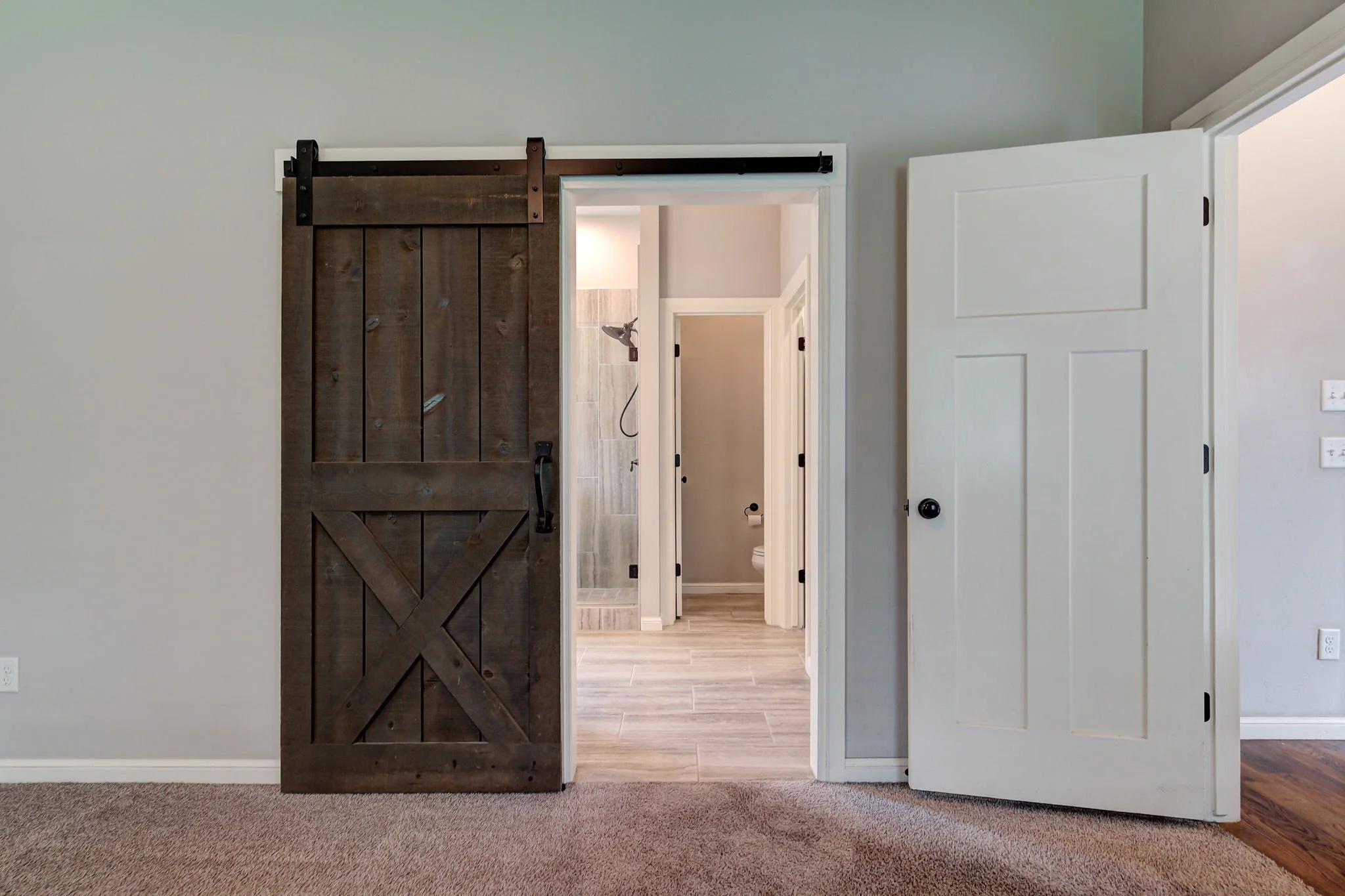 19-sliding-barn-door-ensuite-master-bathroom-entry.jpg