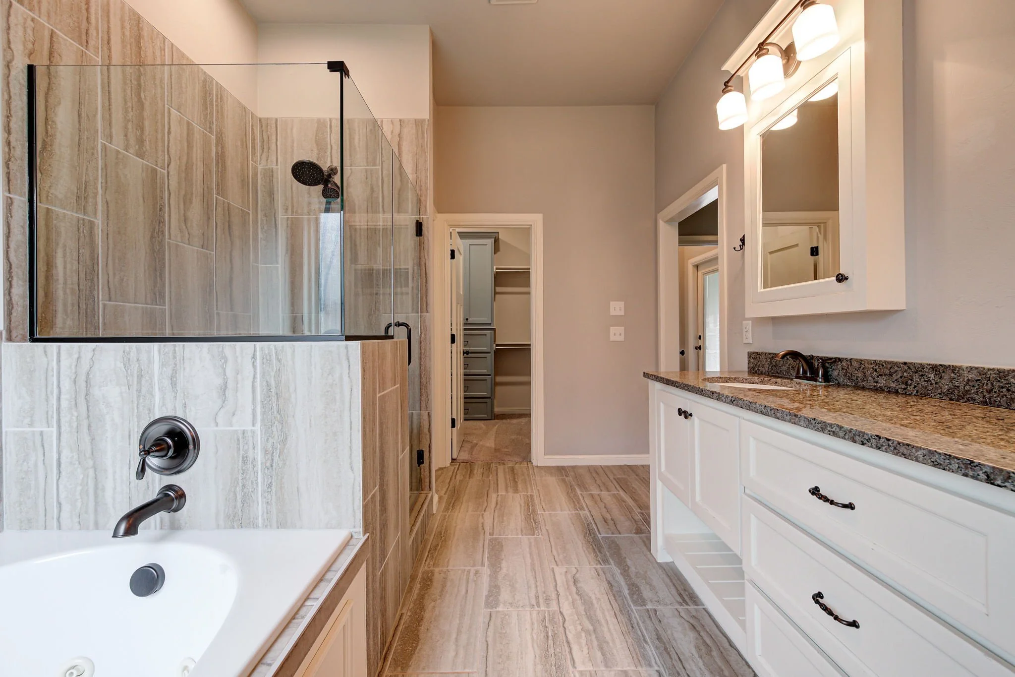 24-master-bathroom-vanity-tub-walk-in-closet-access.jpg