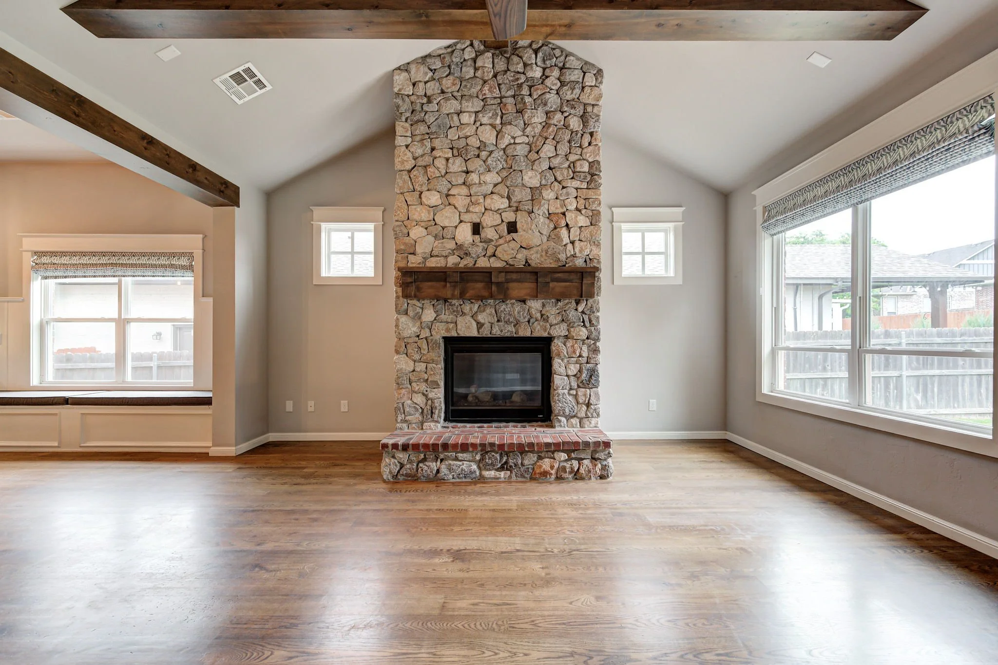 07-great-room-stone-fireplace-hardwood-floors.jpg