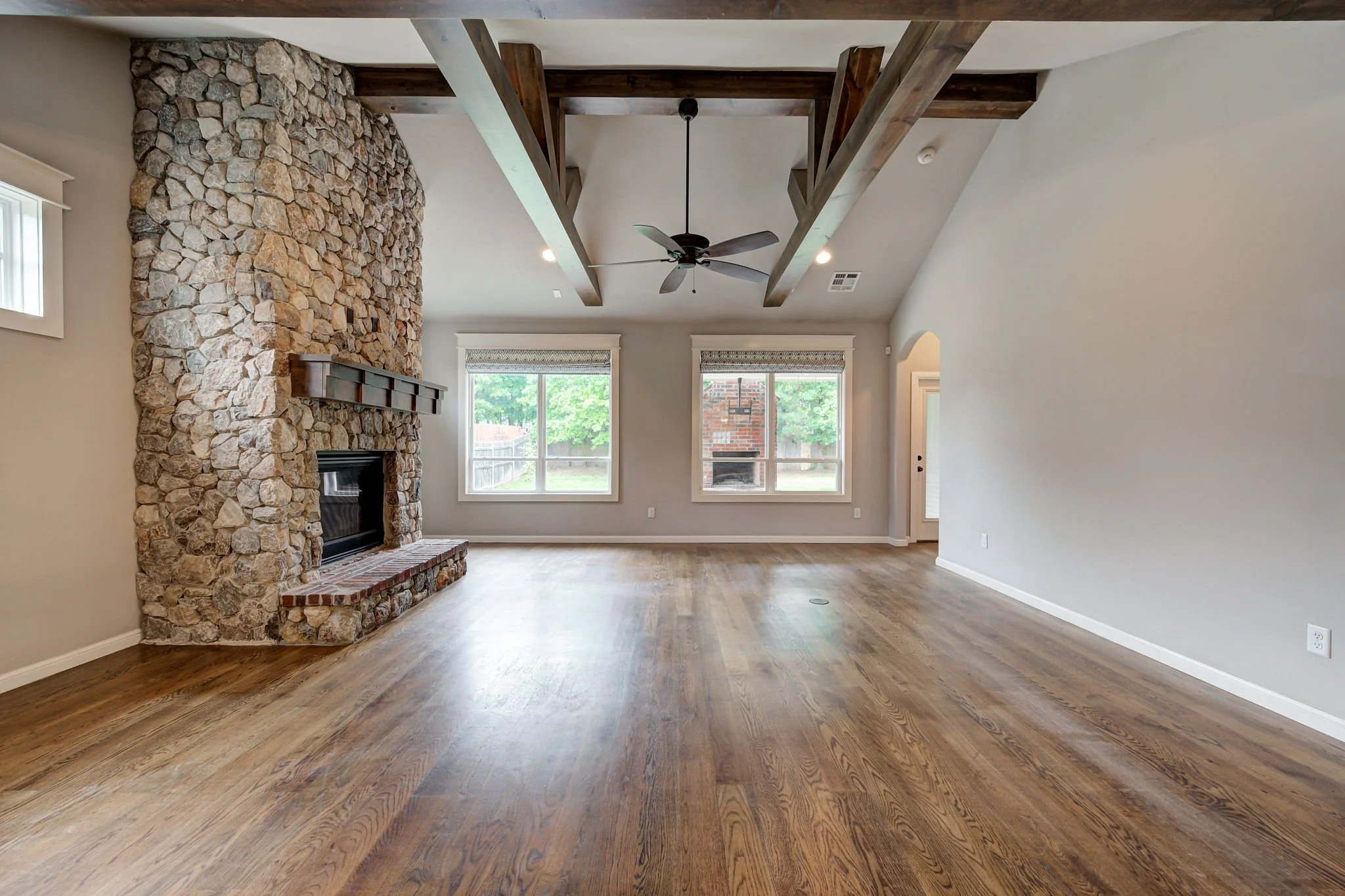 06-living-room-stone-fireplace-wood-beam-ceiling.jpg