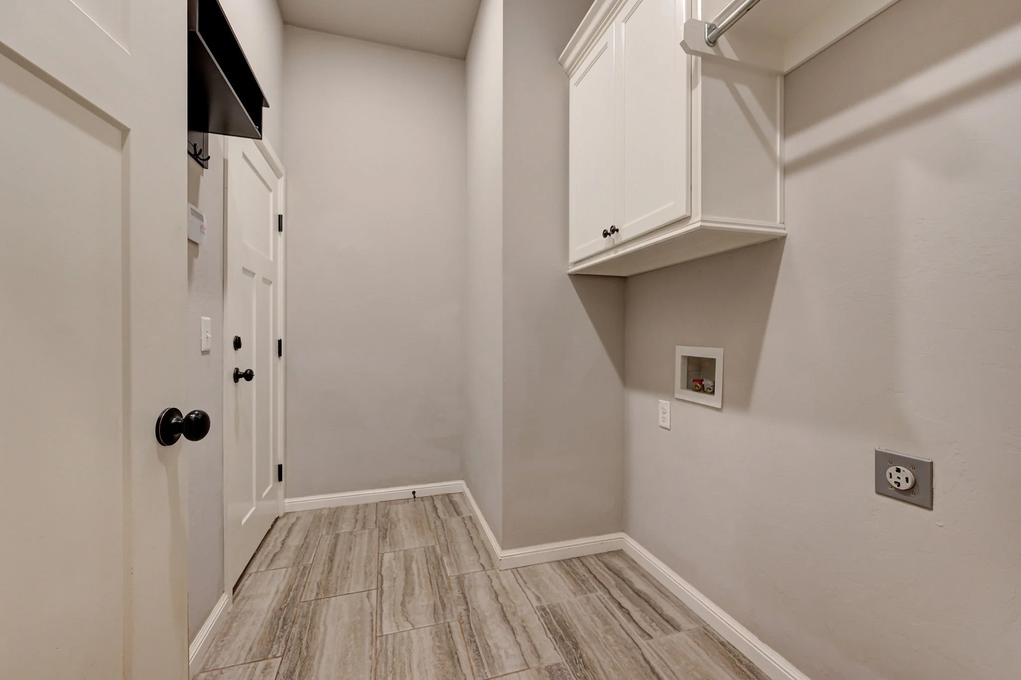 32-laundry-room-tile-floor-washer-dryer-hookups.jpg