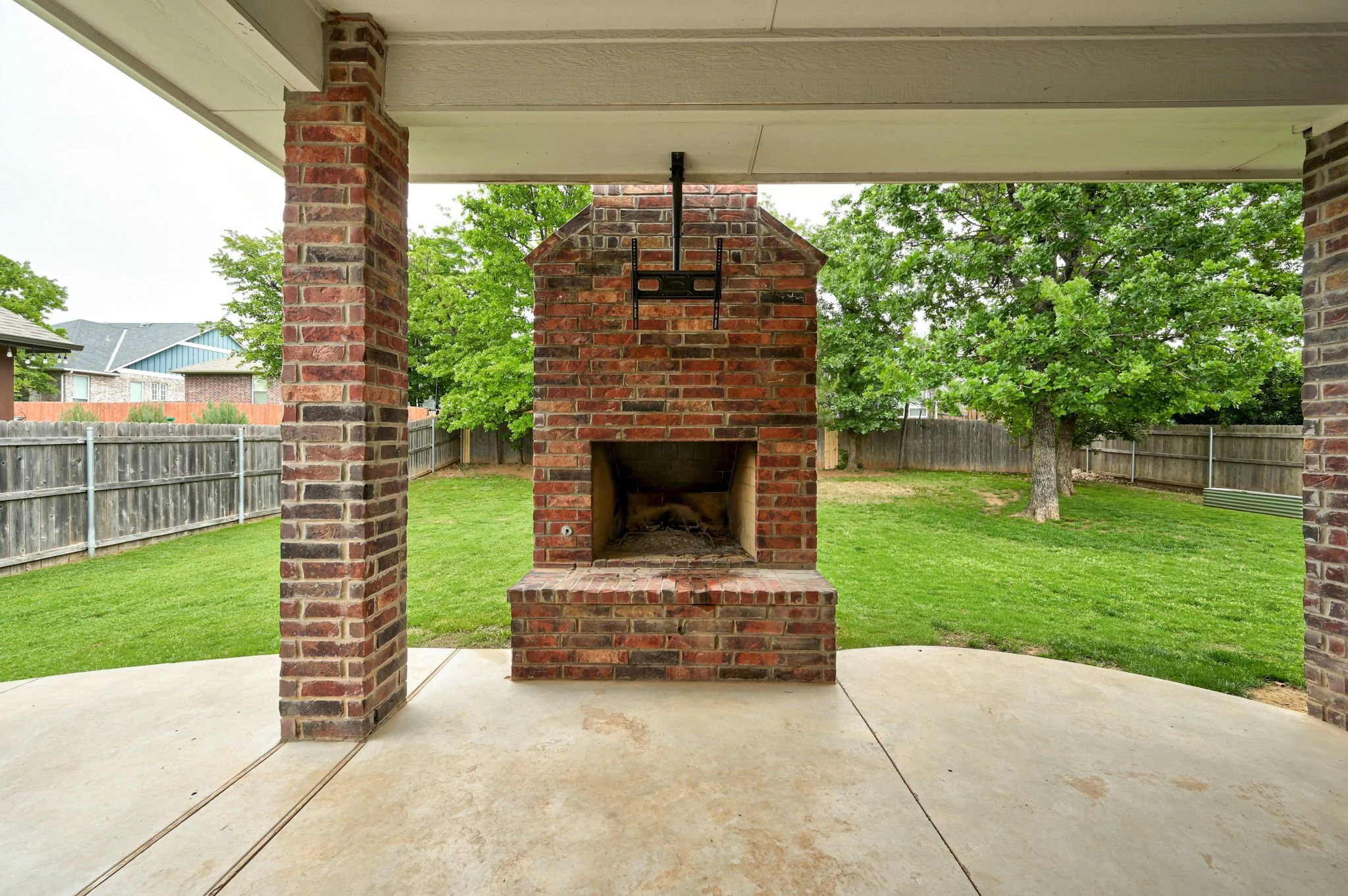 33-covered-patio-outdoor-brick-fireplace.jpg