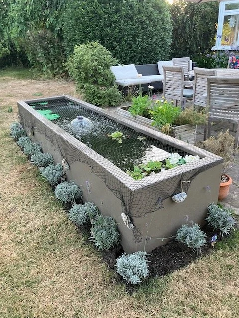 Above ground fibreglass fish pond with timber frame
