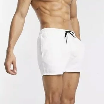 Close-up of a man's lower torso wearing white shorts with a black drawstring.