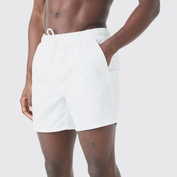 Person wearing white shorts with a drawstring waistband and side pockets.