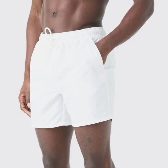 Person wearing white shorts with a drawstring, standing against a plain background.