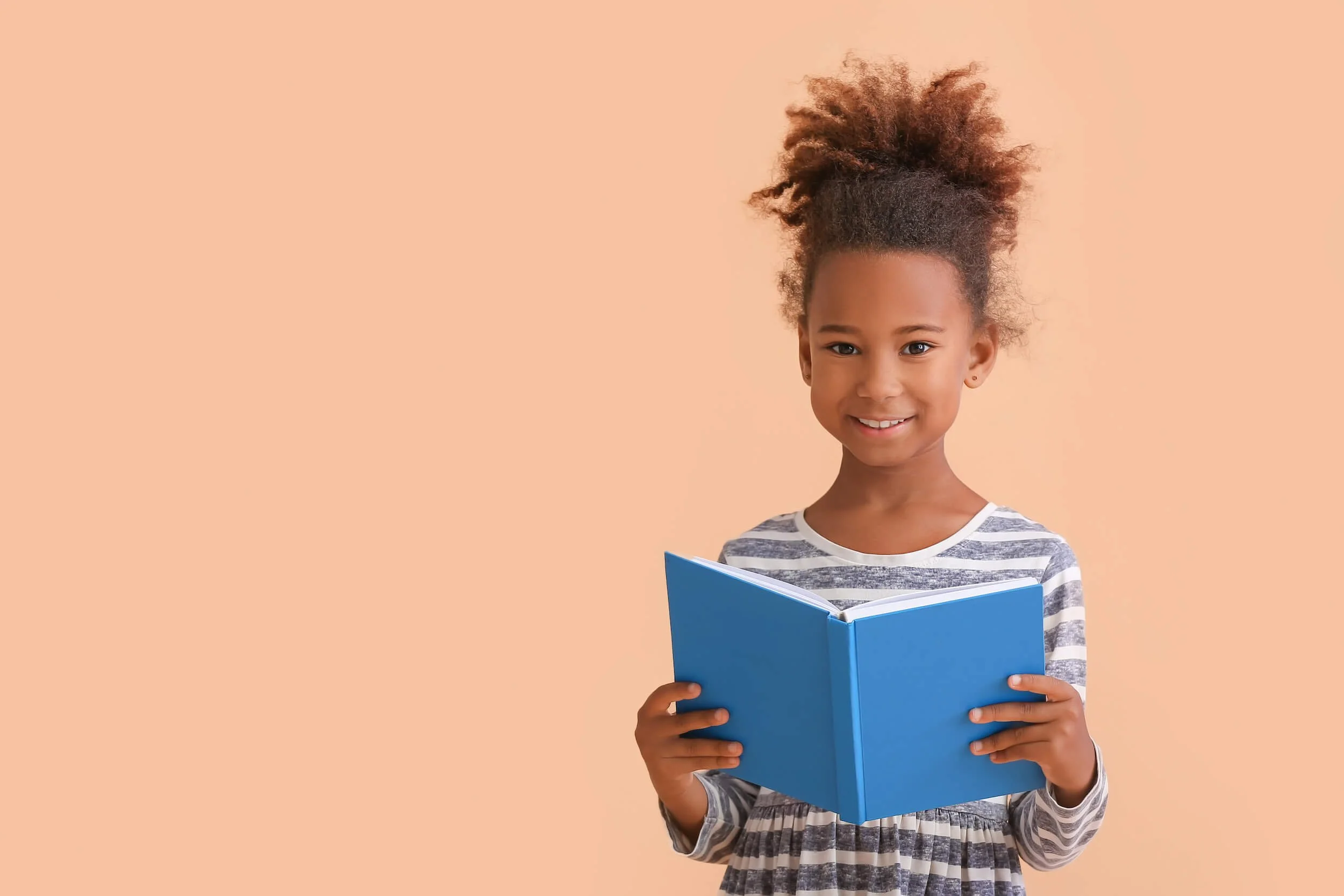 Young student reading a blue book