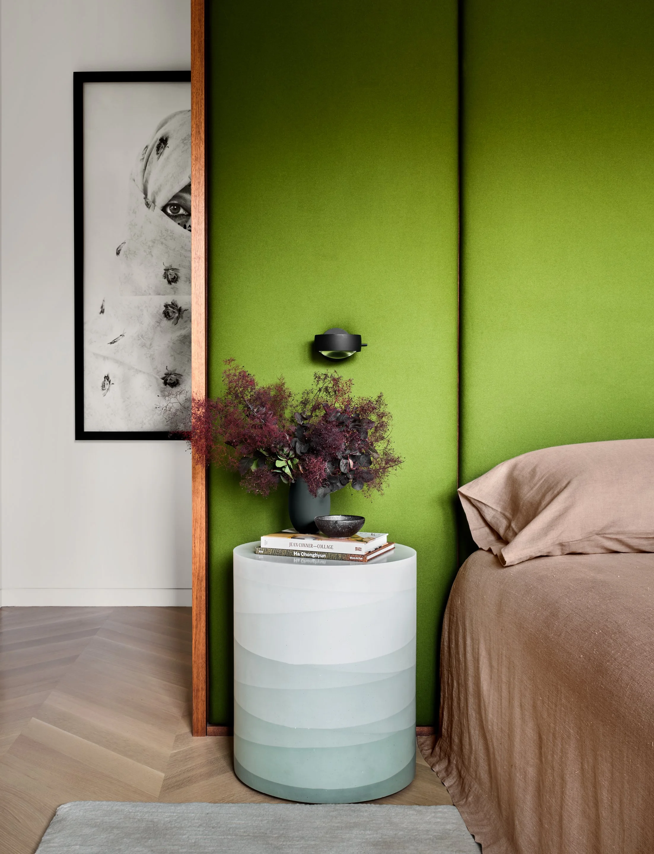 Primary bedroom with moss green upholstered headboard wall, Fernando Mastroantonio ombre drum side table, and Asuka Anastacia Ogawa black and white portrait photograph — Russian Hill San Francisco interior design by Studio Collins Weir