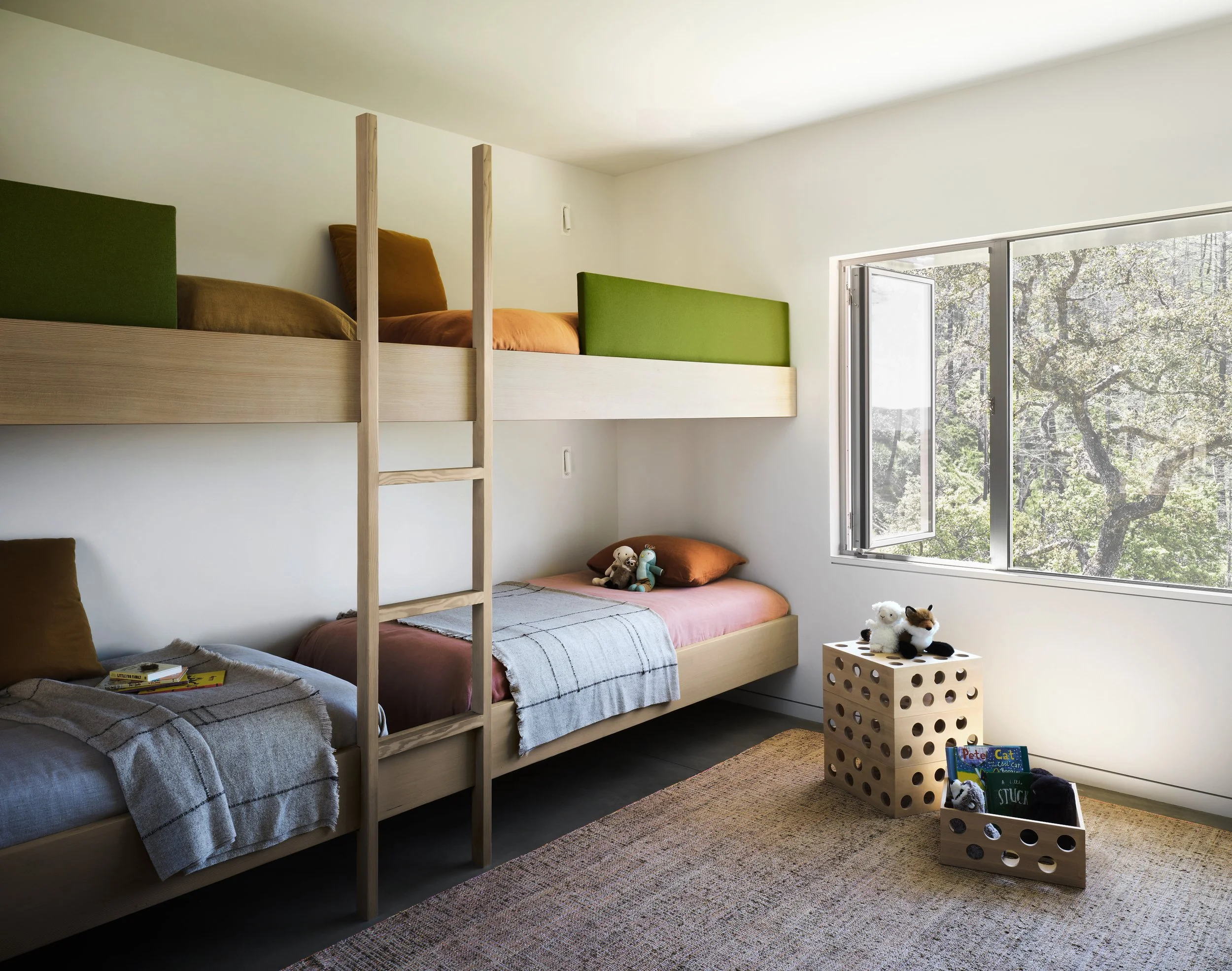 Modern bunk room with custom wood beds, built in ladder, and minimalist kids room design