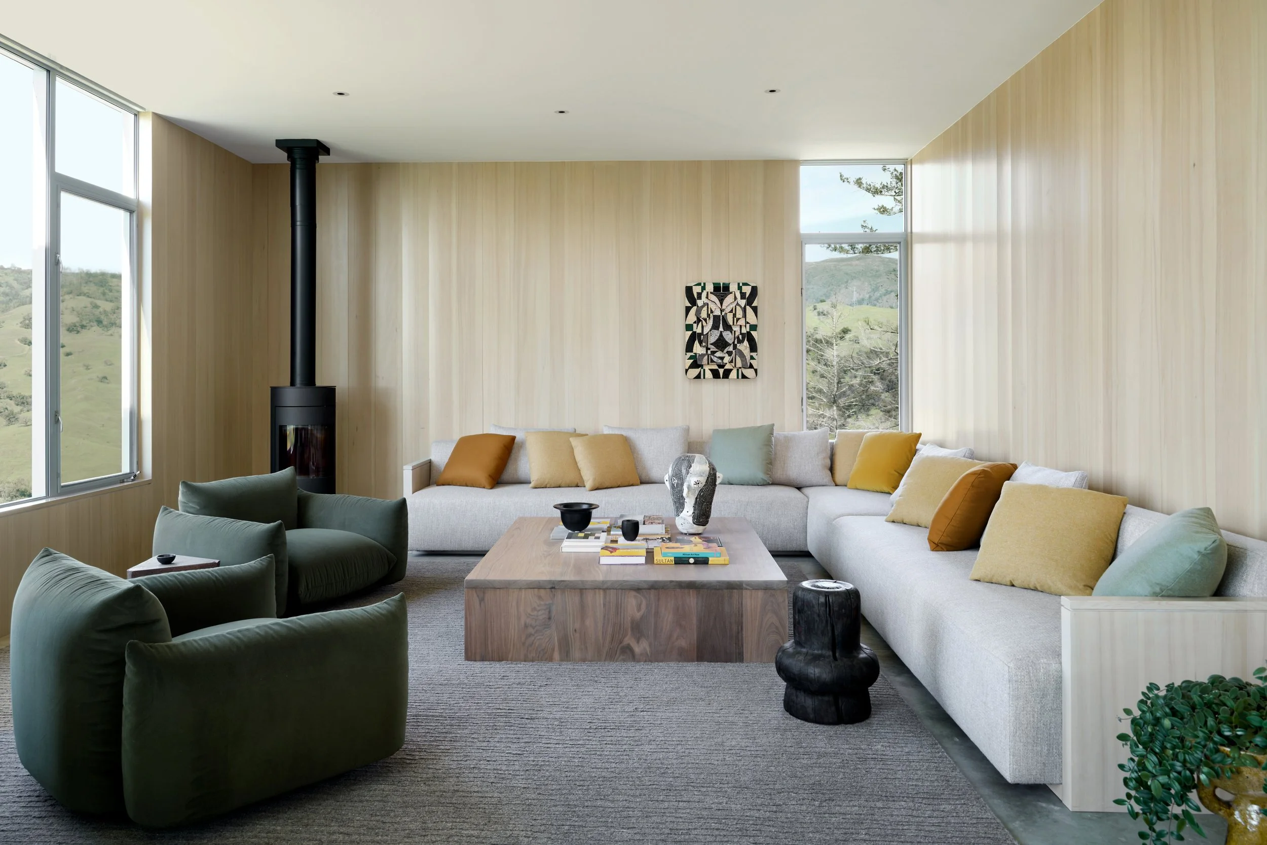 Luxury modern living room interior design with custom sectional and warm wood paneling