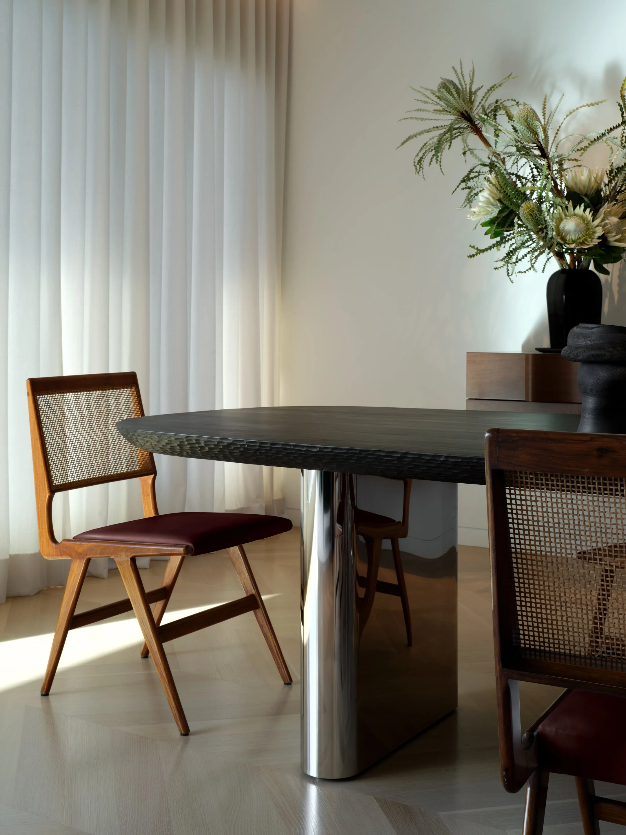 Martin Eisler cane and leather dining chair alongside the Hover Table by Studio Collins Weir — dining room detail, Russian Hill San Francisco interior design by Studio Collins Weir