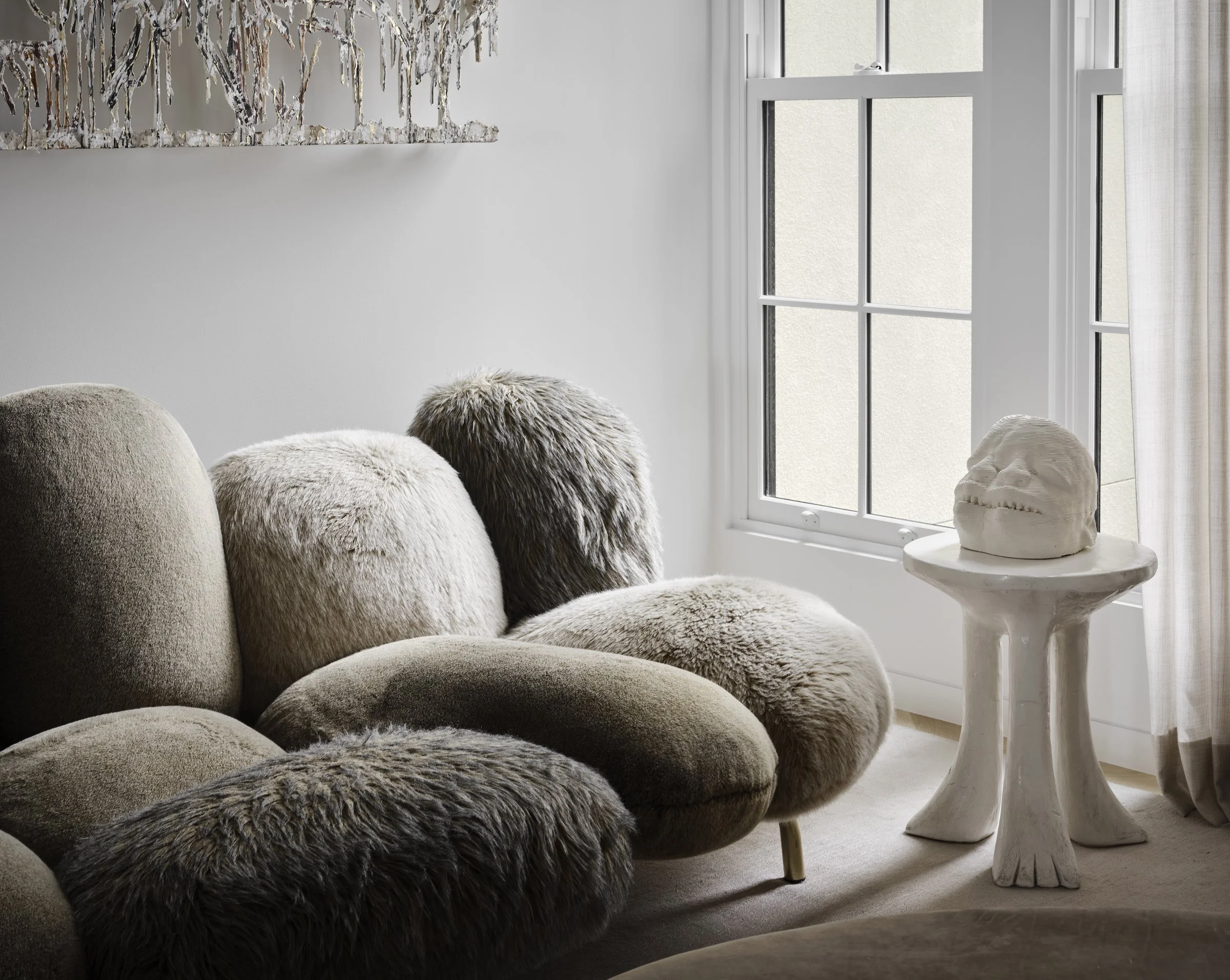 Campana Brothers shearling sofa, Matthew Angelo Harrison skull sculpture and pedestal side table, and Diana Al-Hadid wall sculpture — Russian Hill San Francisco interior design by Studio Collins Weir