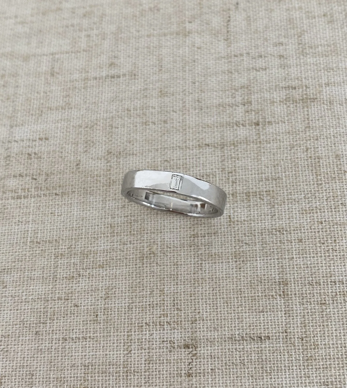 Paul’s Wedding Band - 14k white gold band with a flush set baguette diamond with a high polish