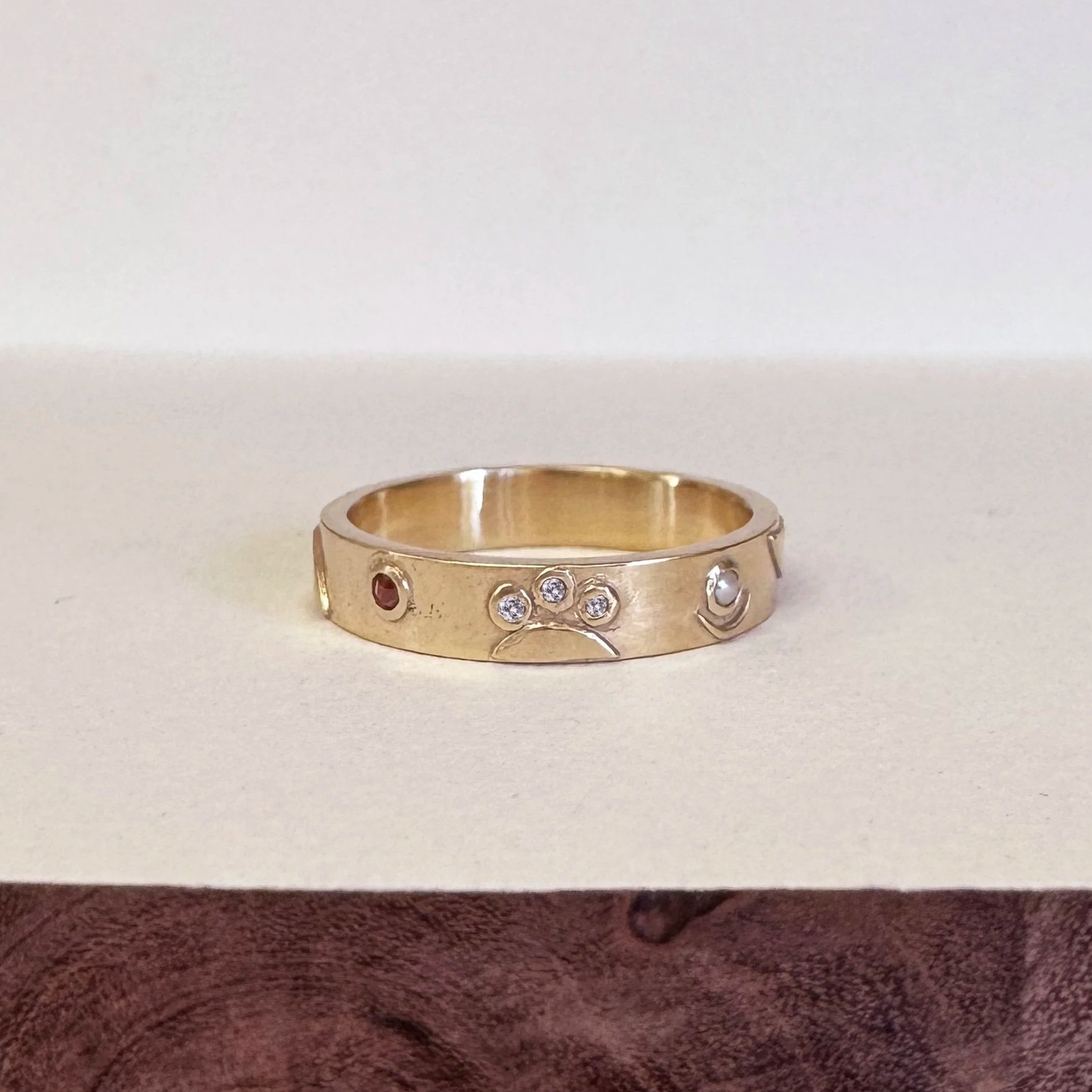 Julia’s Wedding Ring - 14k gold ring made from the customer’s repurposed gold and diamonds, with garnet and pearl