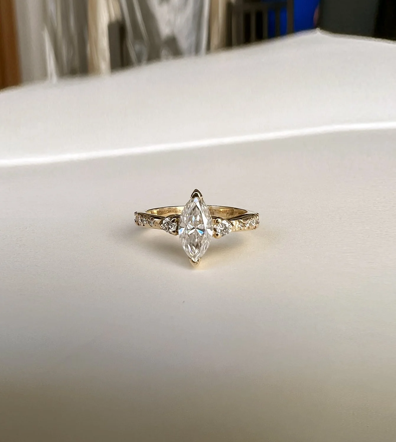 Allie’s Engagement Ring - 14k gold ring with a marquise cut 0.9 ct stone center and round diamond side accents