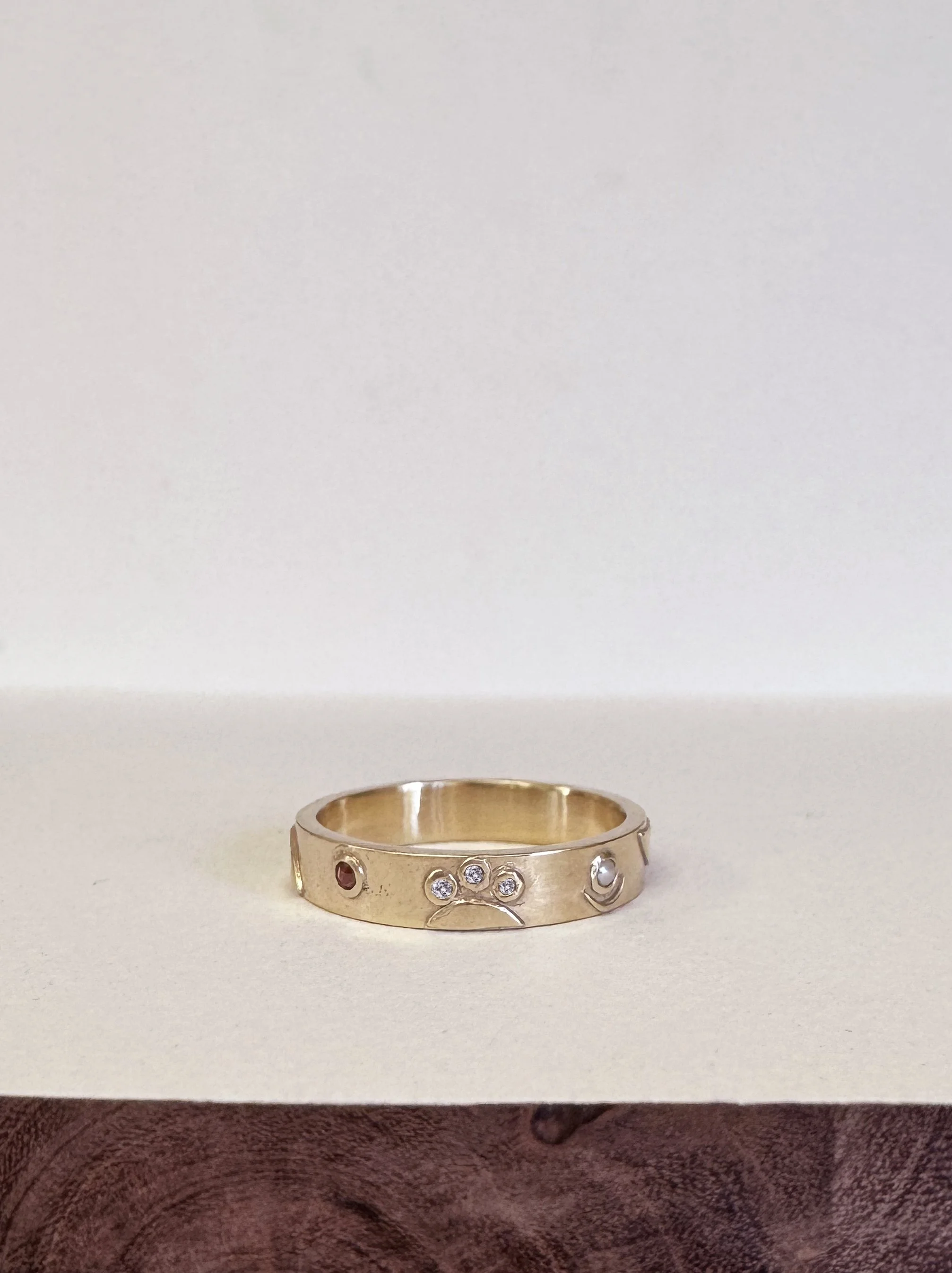 Julia’s Wedding Ring - 14k gold ring made from the customer’s repurposed gold and diamonds, with garnet and pearl