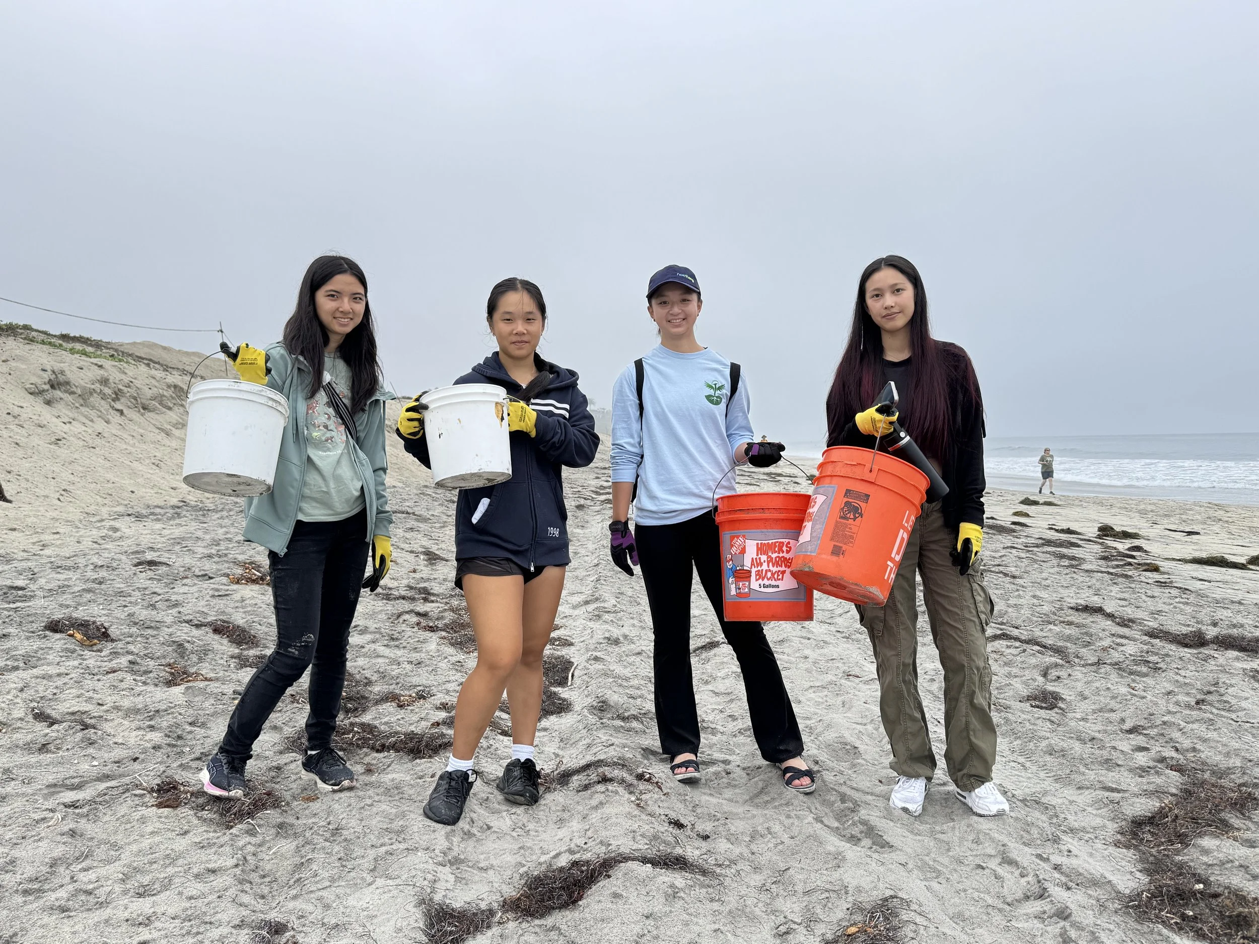 Four volunteers cleaning up trash at Cardiff State Beach. 9/20/25