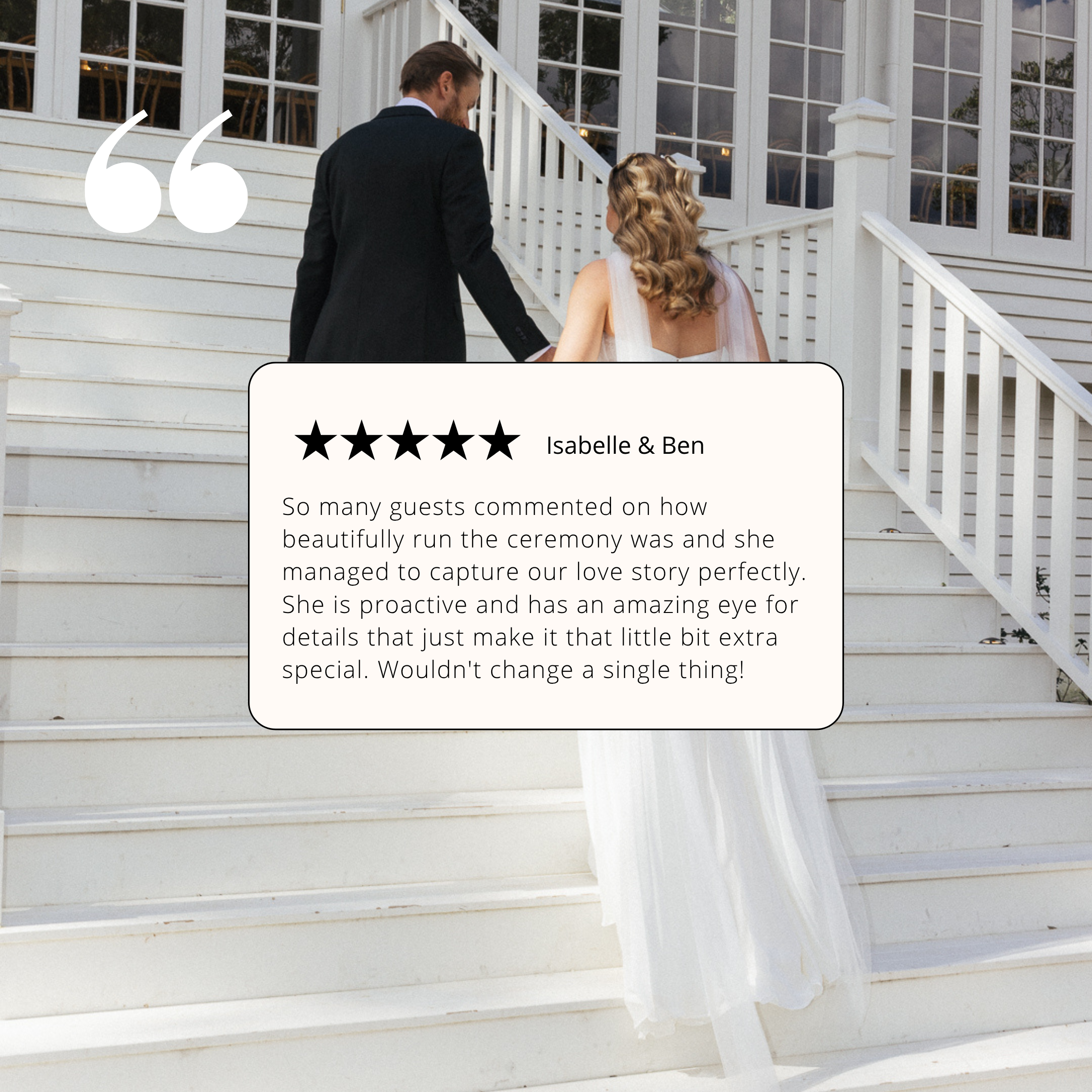 Man and woman dressed in wedding attire walking up white stairs outside a house with large windows.
