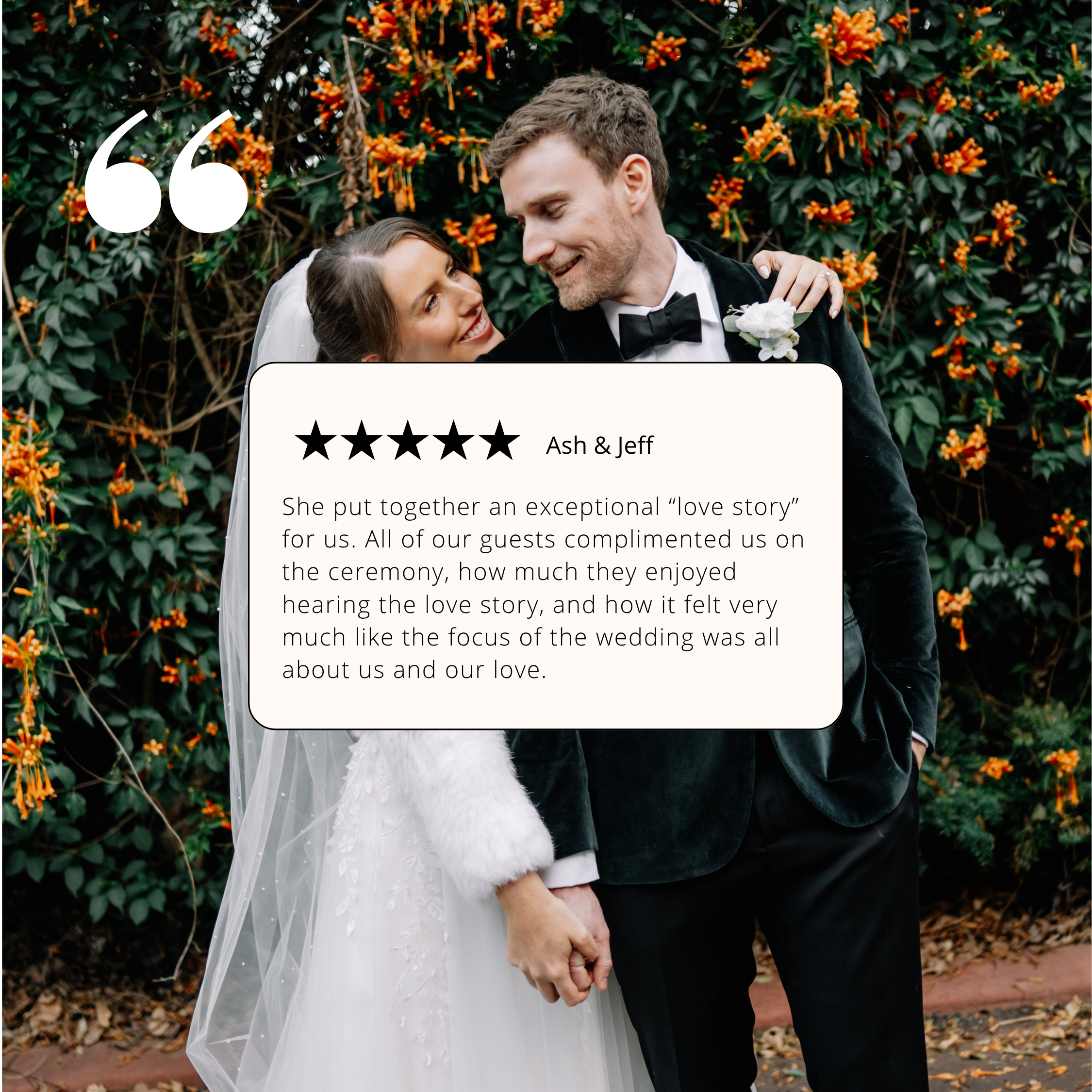 A bride and groom holding hands outdoors with a background of green foliage and orange flowers. The bride is wearing a white dress and veil, while the groom is dressed in a black tuxedo with a bow tie and a boutonniere. They are smiling and looking at each other.
